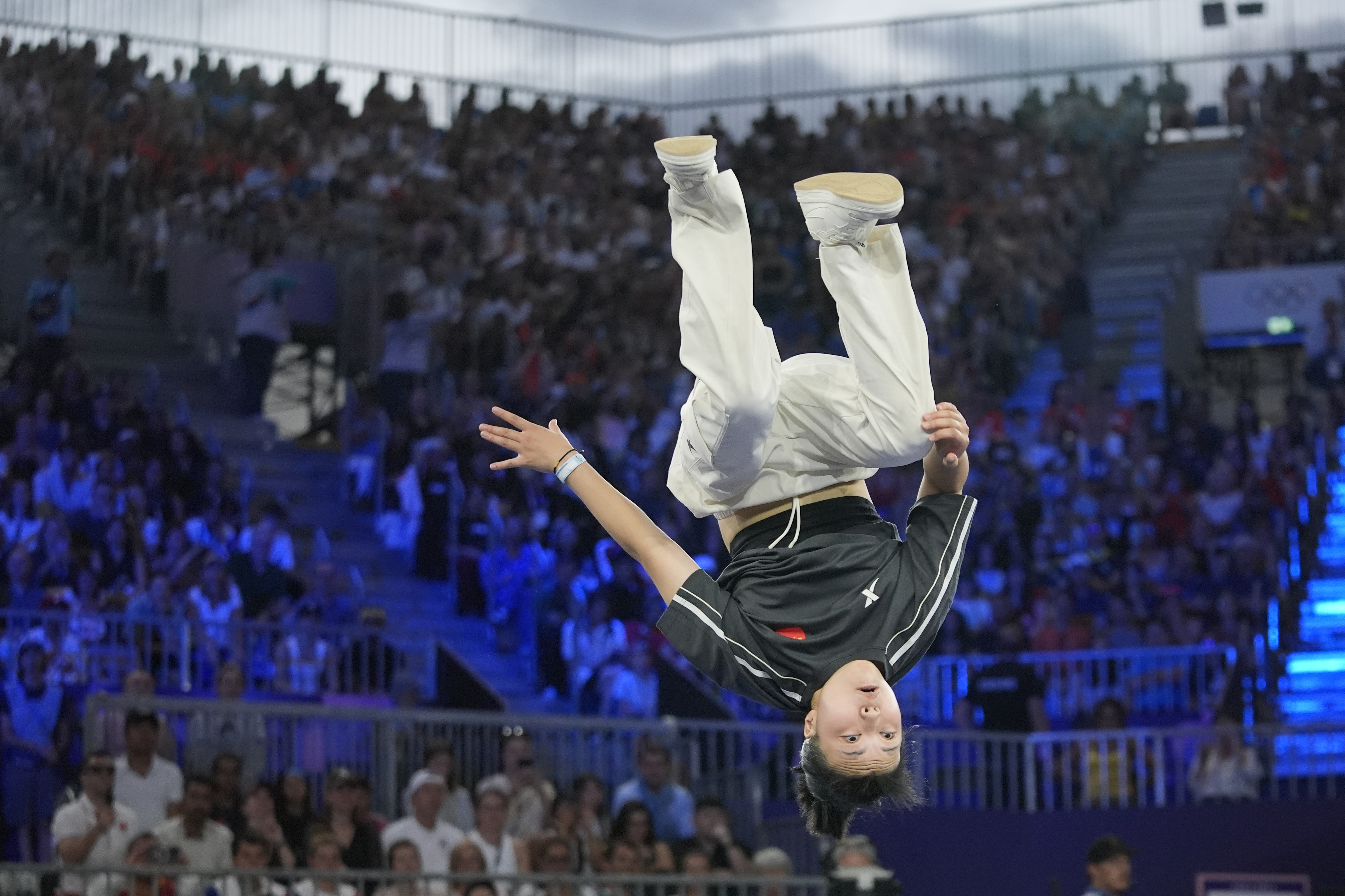 China's Qingyi Liu, known as B-Girl 671, competes during the B-Girls bronze medal battle at the breaking competition at La Concorde Urban Park at the 2024 Summer Olympics, Friday, Aug. 9, 2024, in Paris, France. (AP Photo/Frank Franklin)