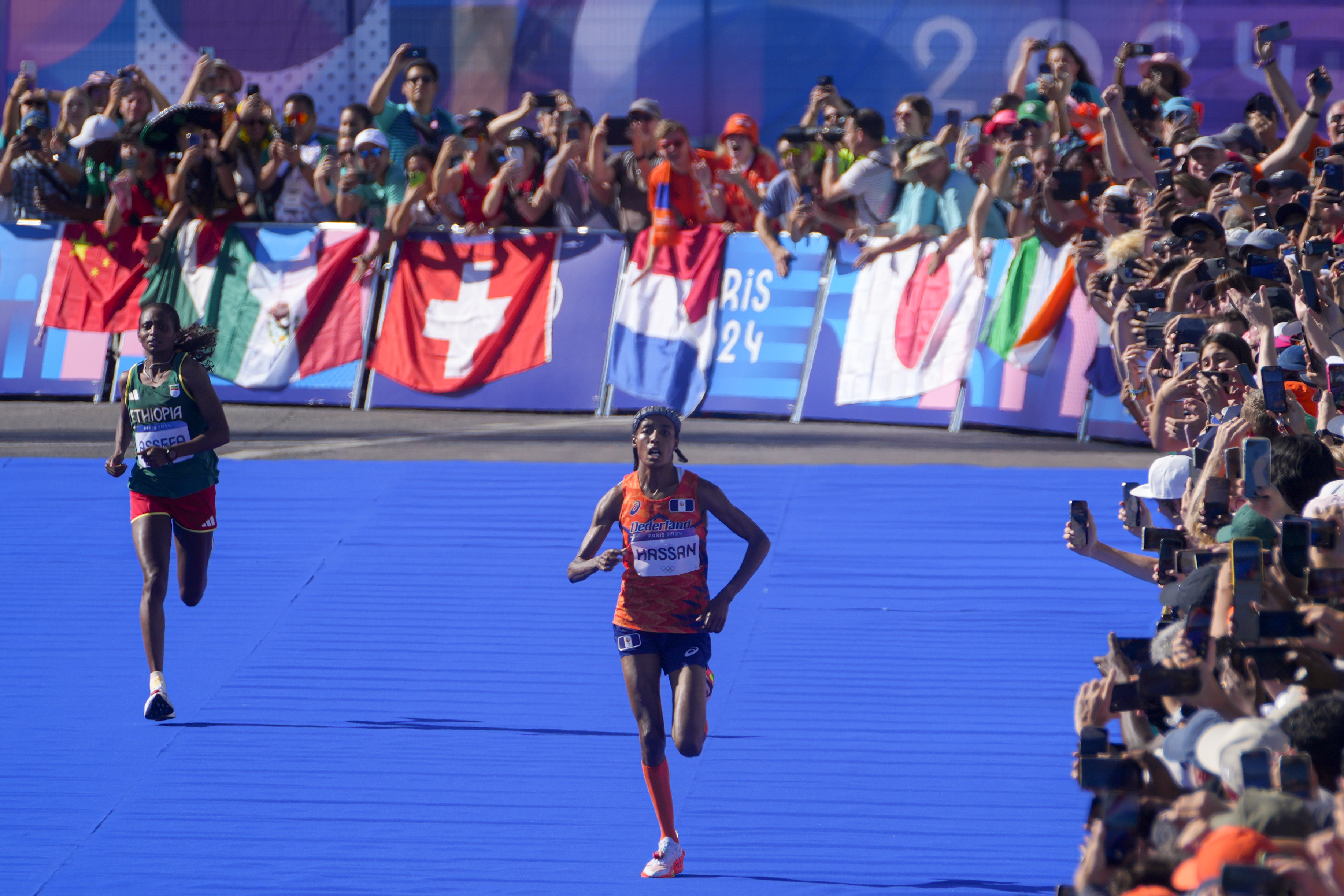 Sifan Hassan, of the Netherlands, right, and Ethiopia's Tigst Assefa, left, approach the finish line at the end of the women's marathon competition at the 2024 Summer Olympics, Sunday, Aug. 11, 2024, in Paris, France. (AP Photo/Dar Yasin)