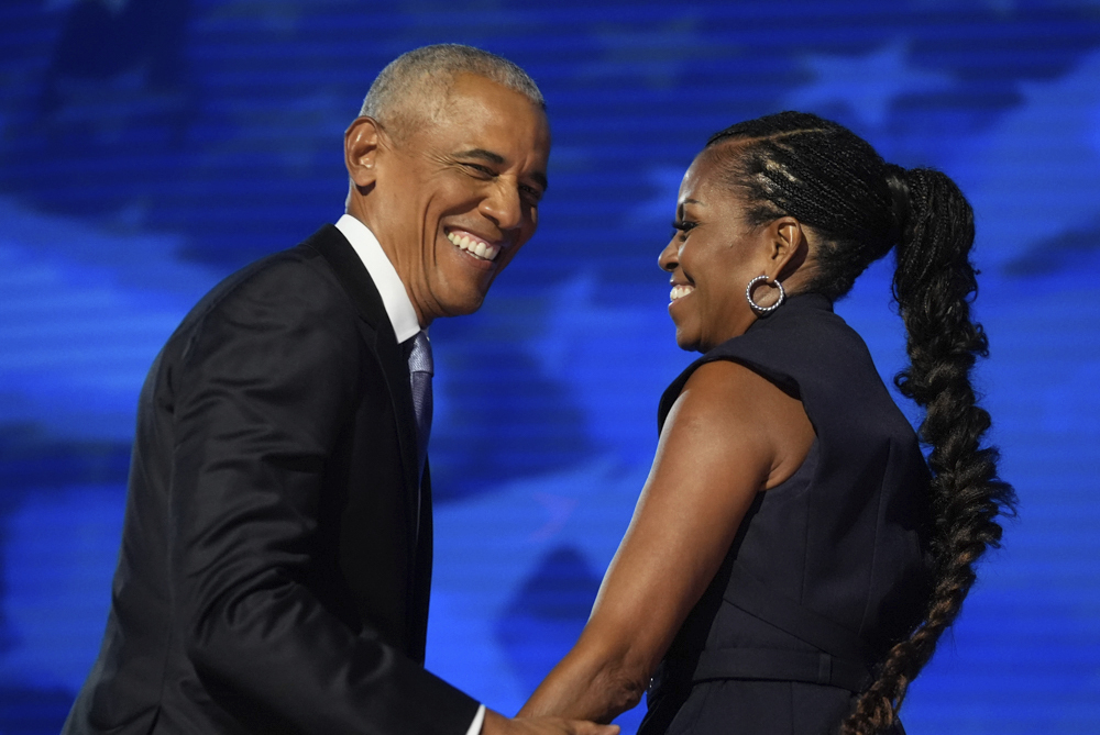 Former President Barack Obama hugs former first lady Michelle Obama as he is introduced during the Democratic National Convention Tuesday, Aug. 20, 2024, in Chicago.