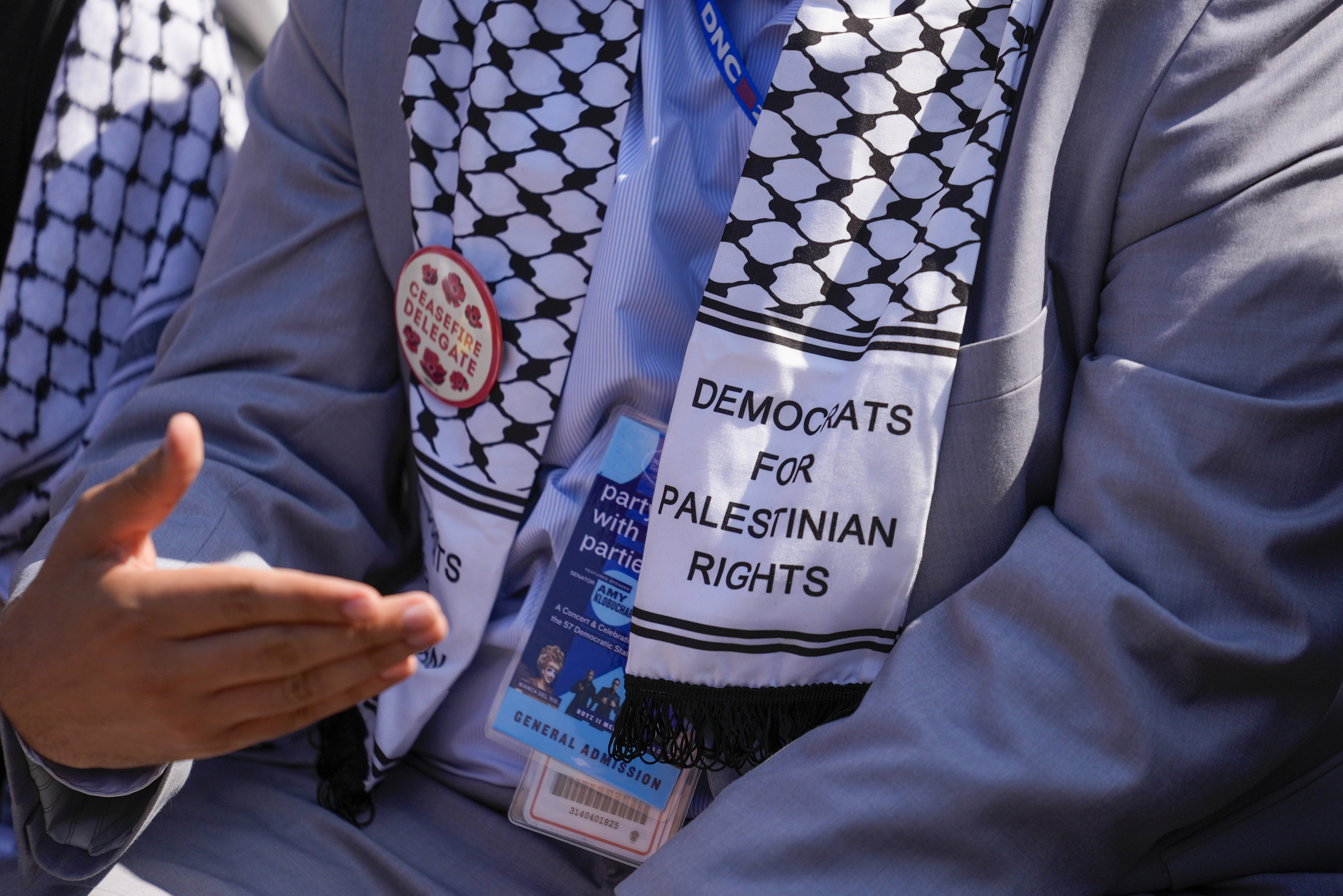 A keffiyeh scarf reads: "Democrats for Palestinian rights"