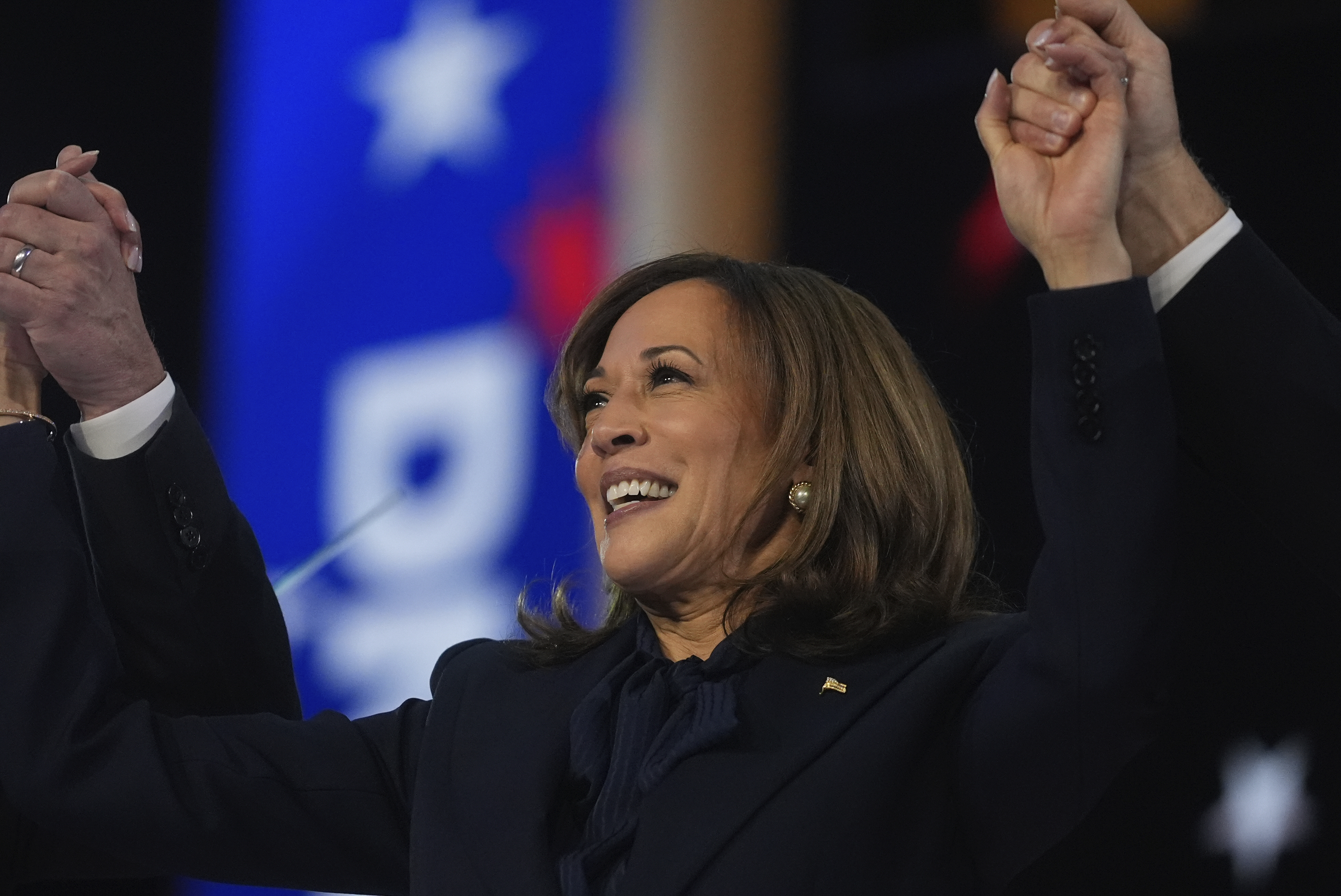 Kamala Harris raises her arms