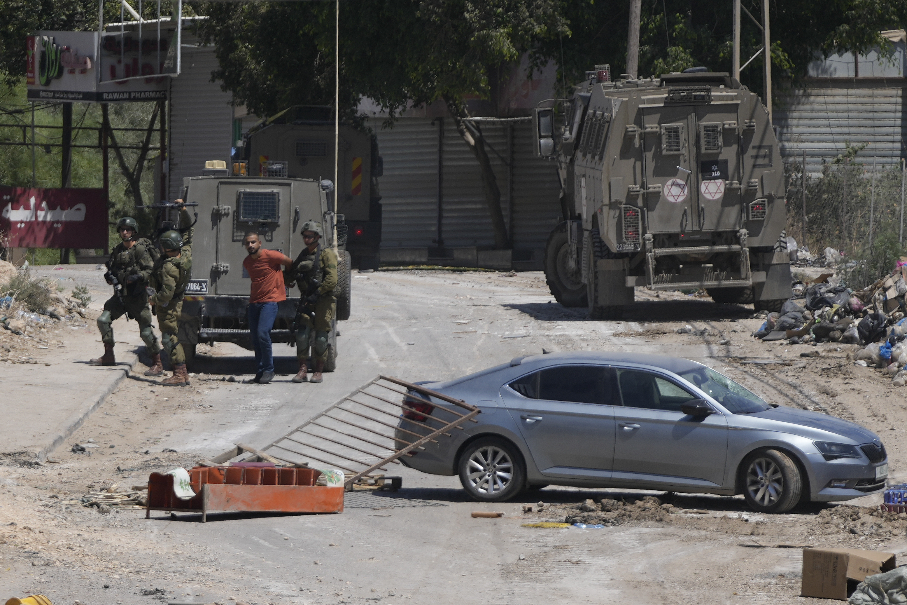The largest Israeli military raid on the occupied West Bank in decades continues with at least 12 Palestinians killed and dozens wounded after the first day of the incursion on Wednesday.