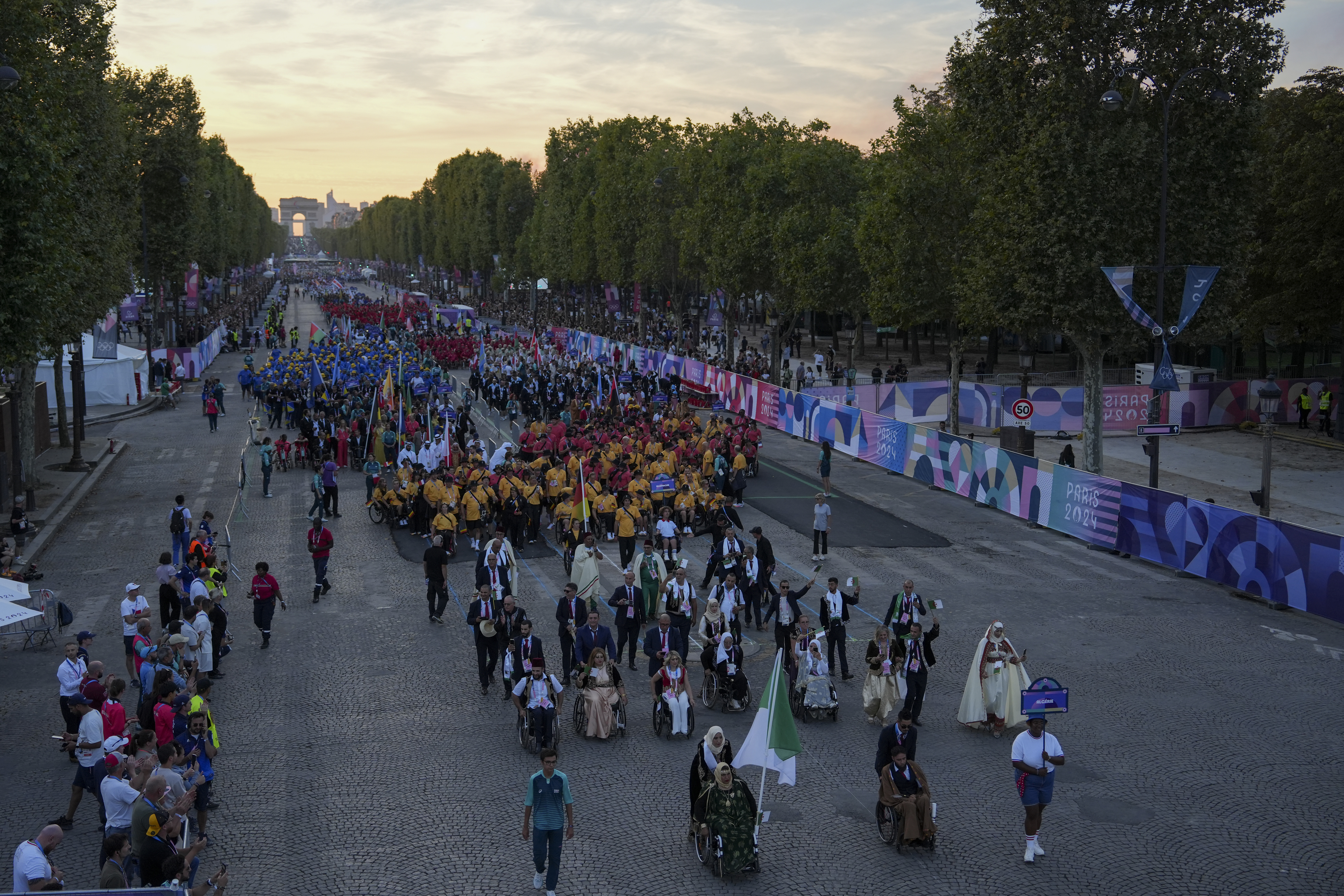 Algeria's delegation march ahead of other delegations as they arrive for the Opening Ceremony for the 2024 Paralympics, Wednesday, Aug. 28, 2024, in Paris, France. (AP Photo/Aurelien Morissard)