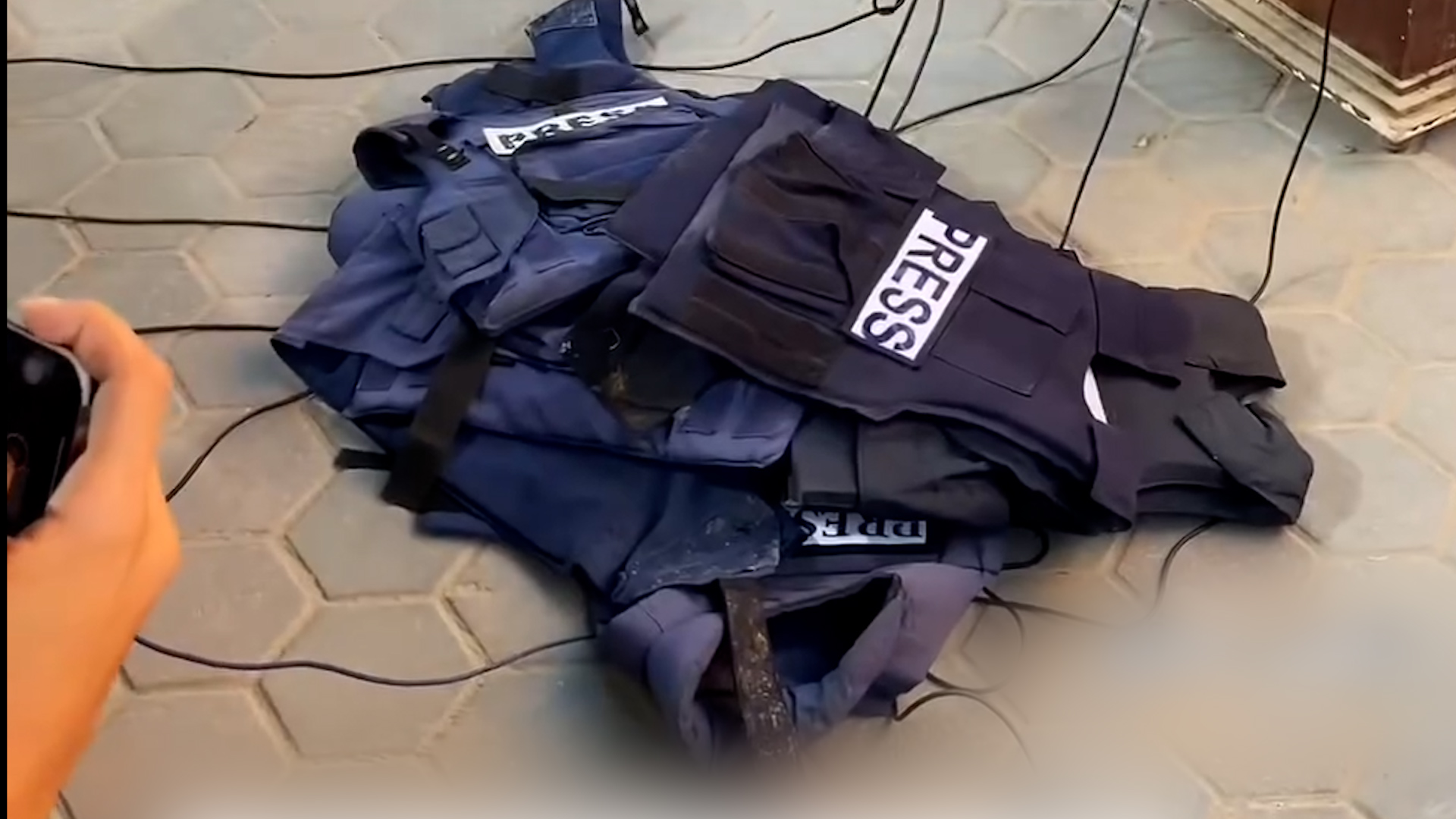 Press vests on the ground as Palestinian journalists in Gaza protest the targeting of press and Al Jazeera colleagues.