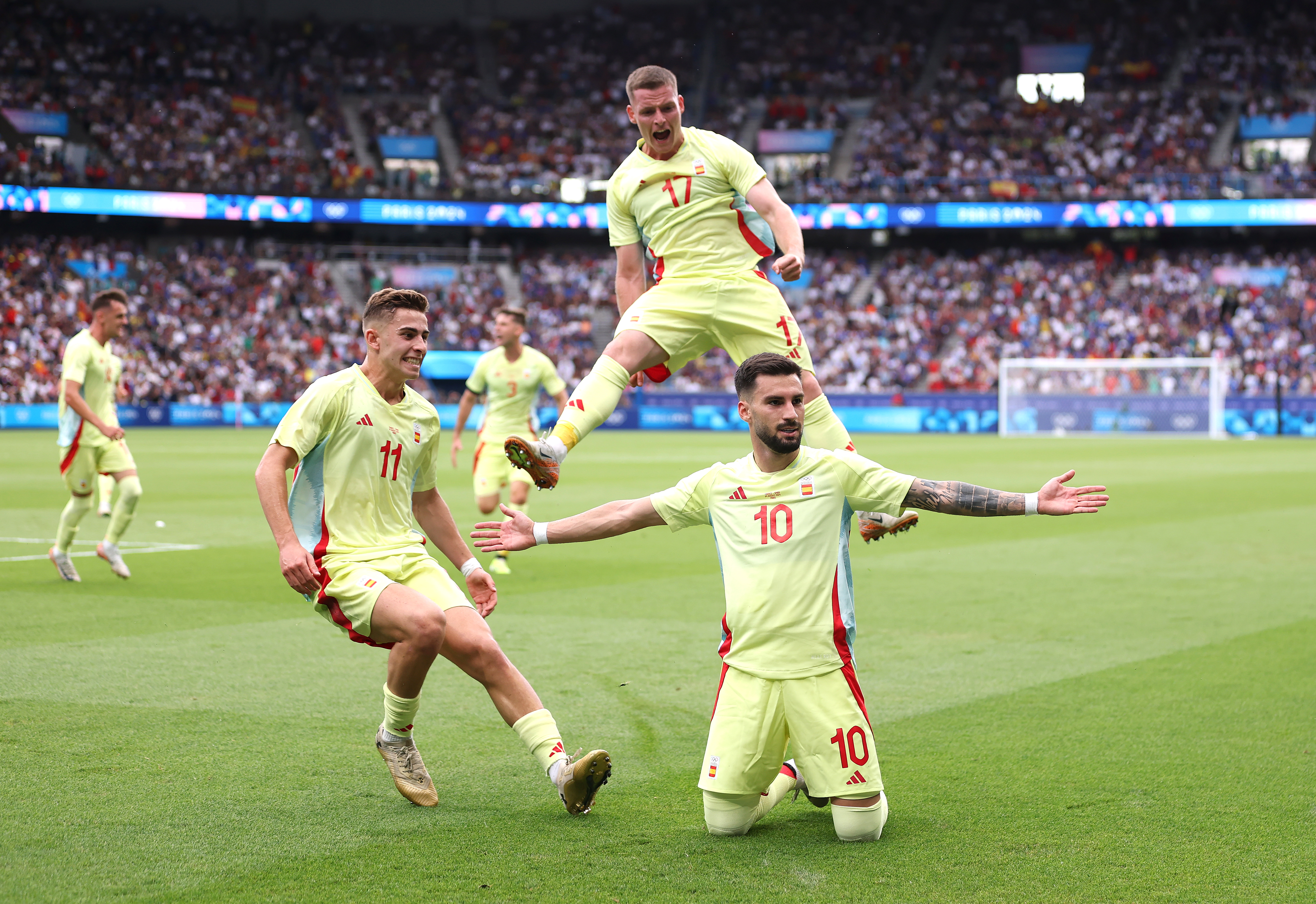 Football players celebrate goal.