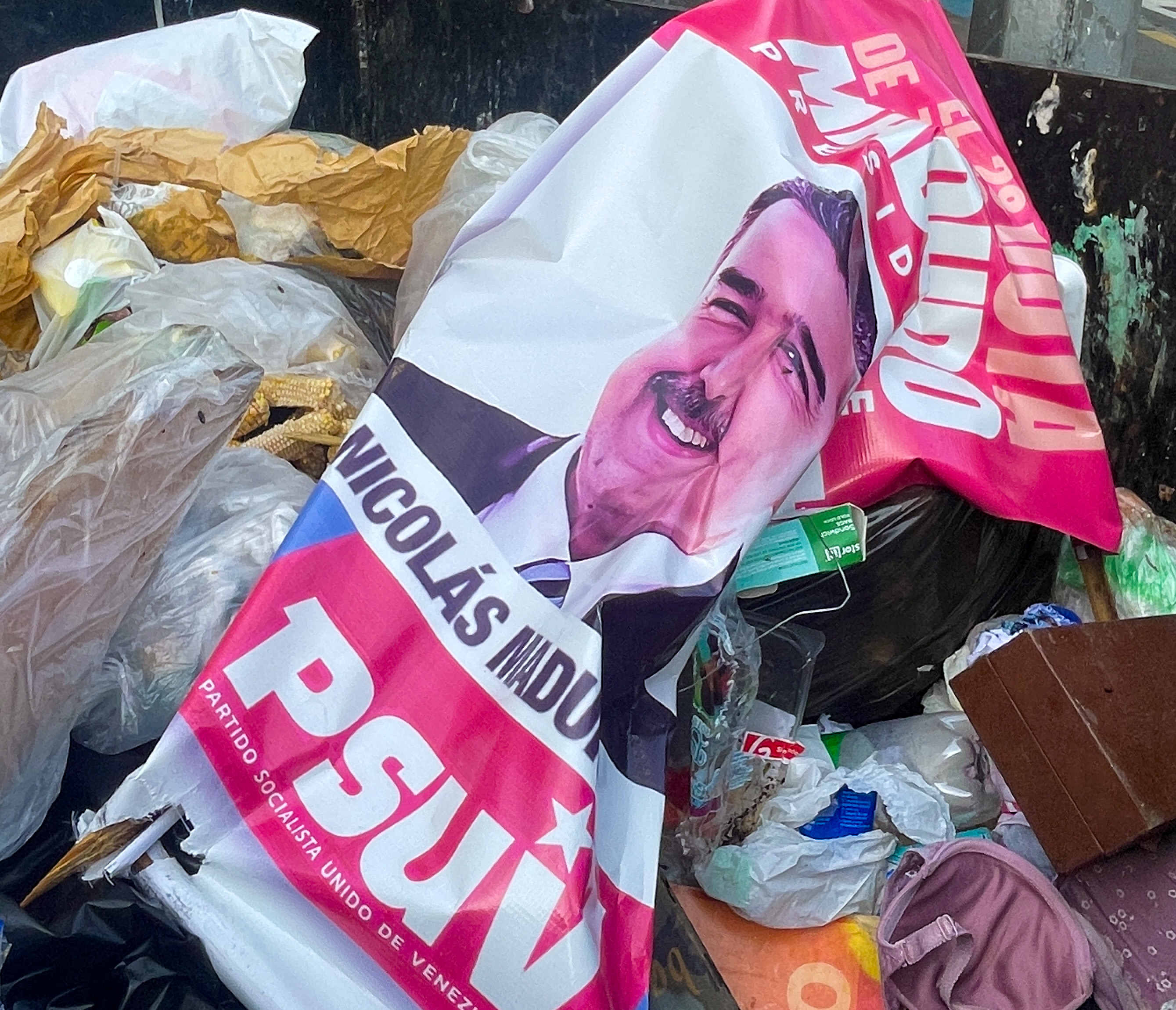 A crumpled-up photo of Maduro in a rubbish heap