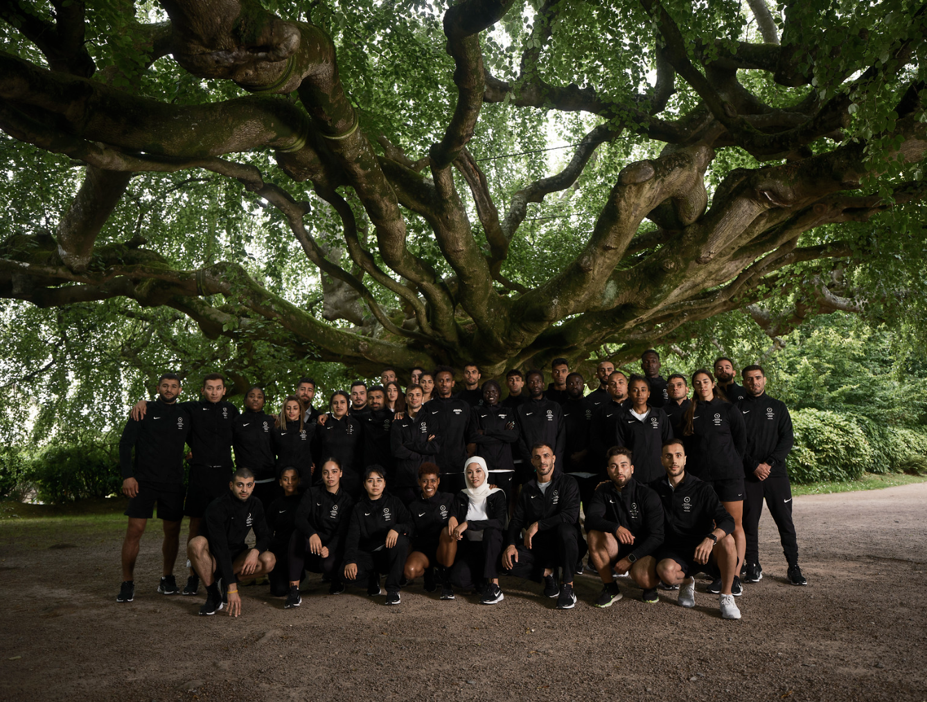 The-2024-Refugee-Olympic-Team-Manizha-4th-from-left-bottom-row-Credit_-©-IOC