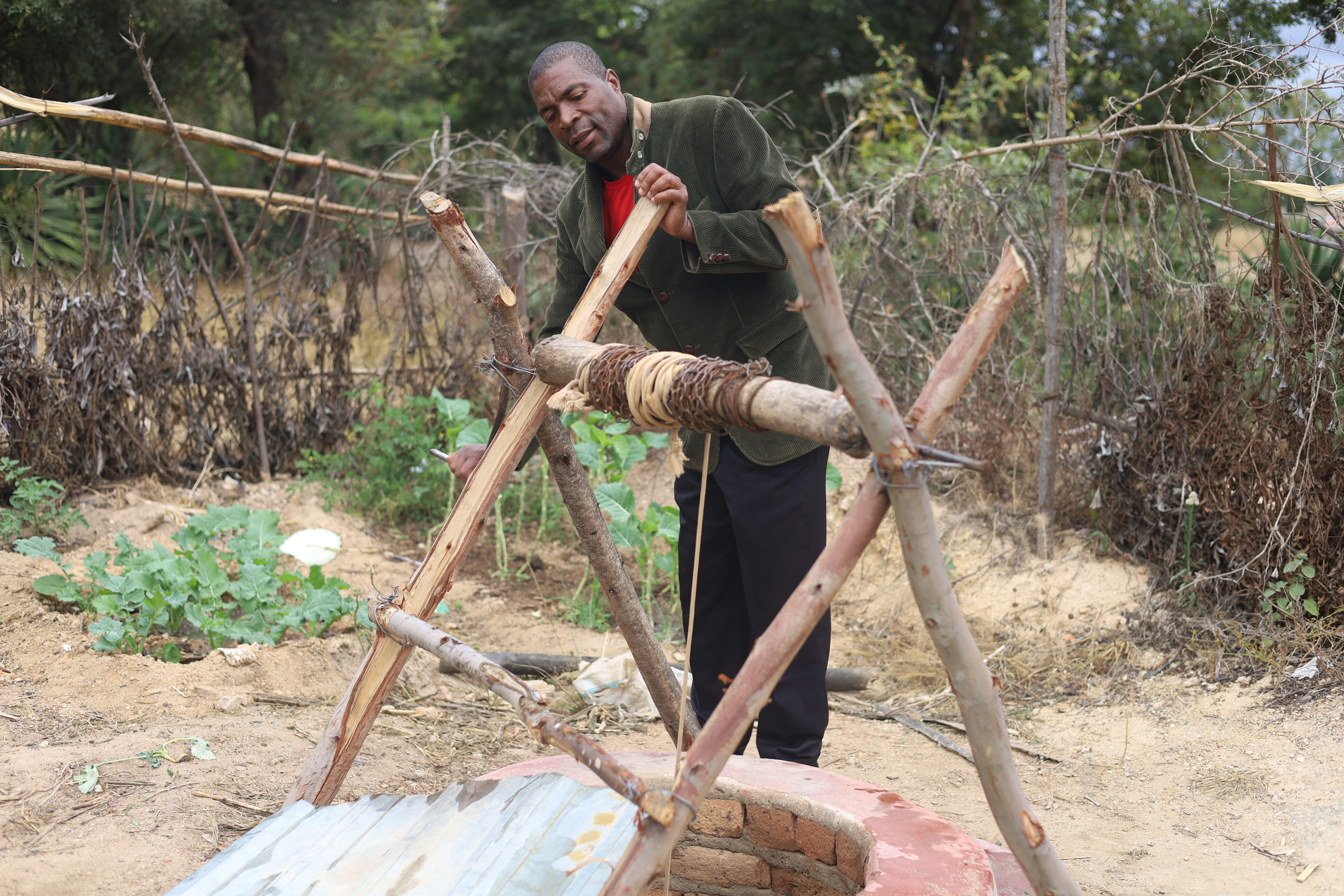 A man fetches water from a well
