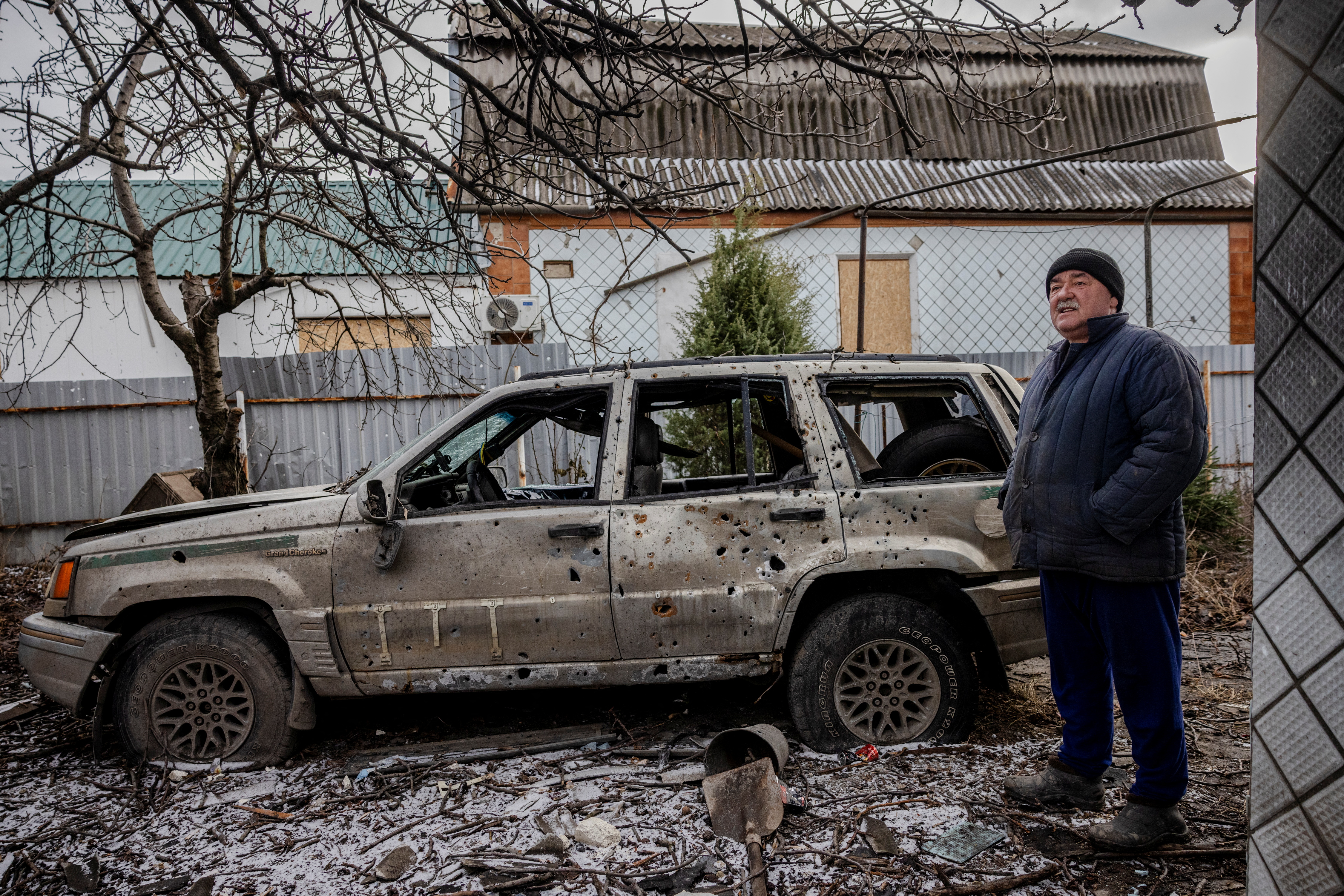 Oleksandr, 60, stands in the yard of his neighbour's house that was destroyed by Russian artillery in the frontline town of Kurakhove where volunteers of Base UA evacuate locals with children, amid Russia’s attack on Ukraine, January 29, 2024. REUTERS/Thomas Peter