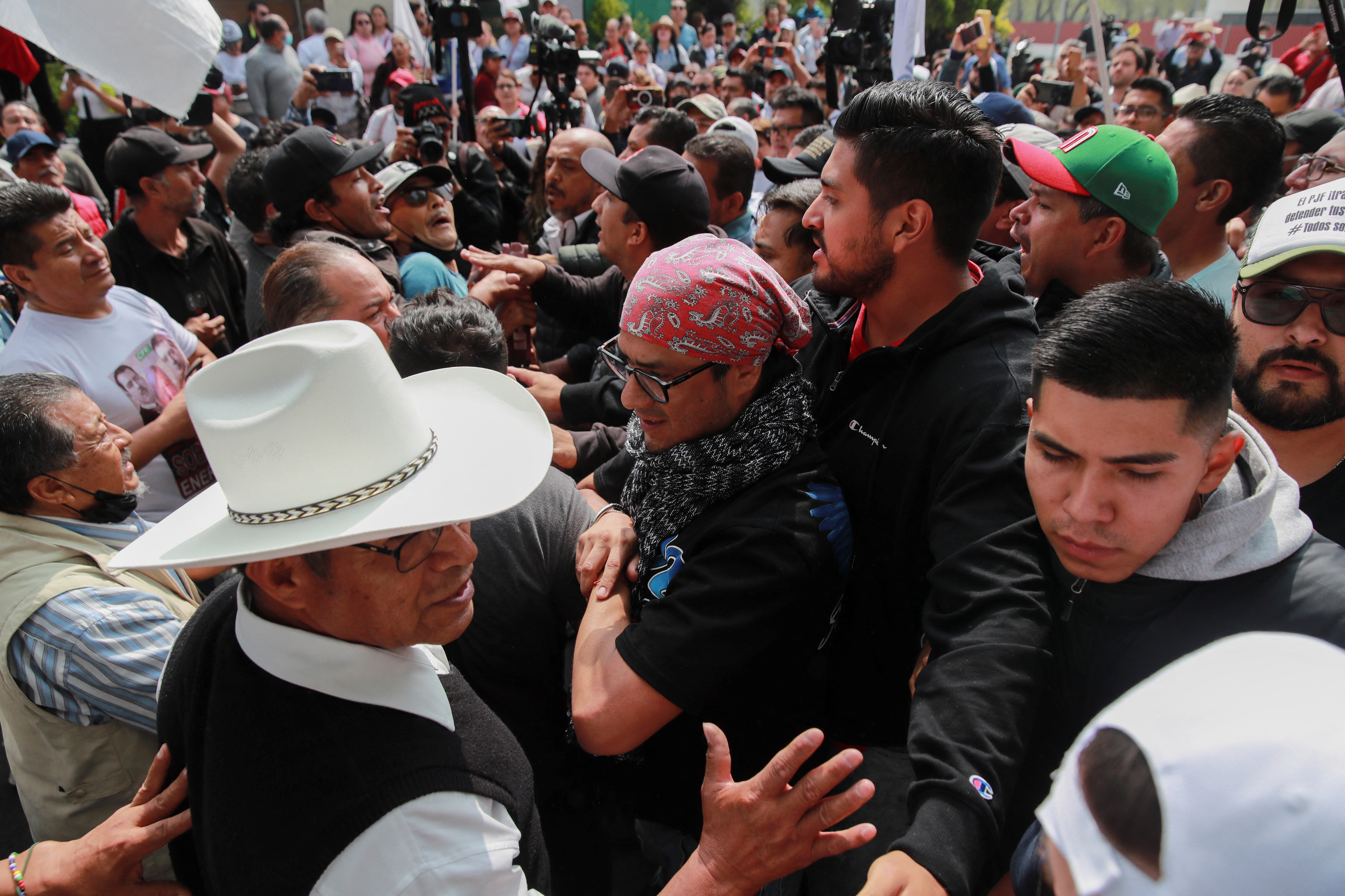 Protesters in the streets of Mexico City, packed together.