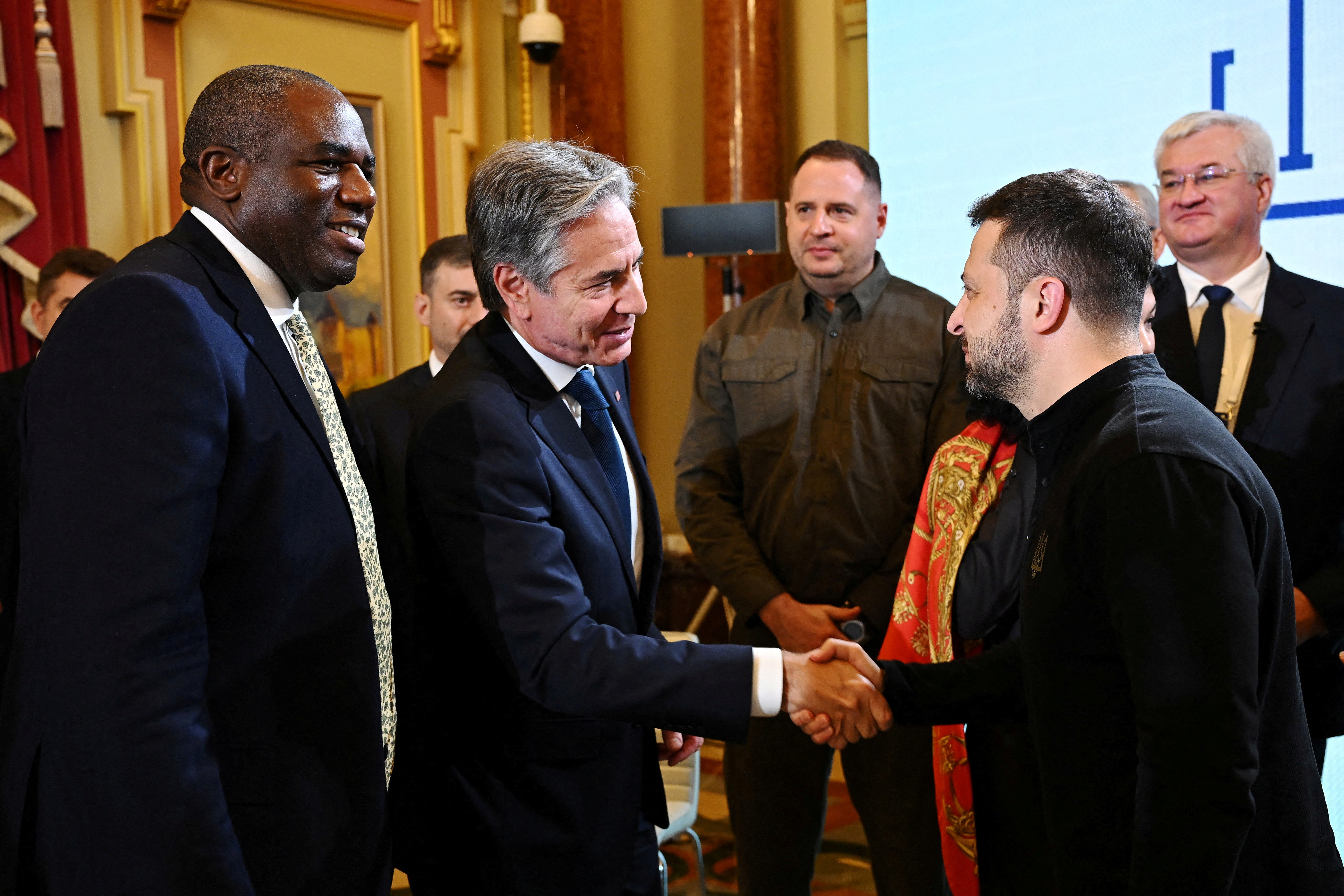 US Secretary of State Antony Blinken, shakes hands with President of Ukraine Volodymyr Zelenskiy as UK Foreign Secretary David Lammy looks on, during the Fourth Crimea Platform Leaders Summit on September 11, 2024 in Kyiv, Ukraine. The British Foreign Secretary joined his American counterpart on a visit to Ukraine to discuss the country's military needs in its fight against Russia. Leon Neal/Pool via REUTERS