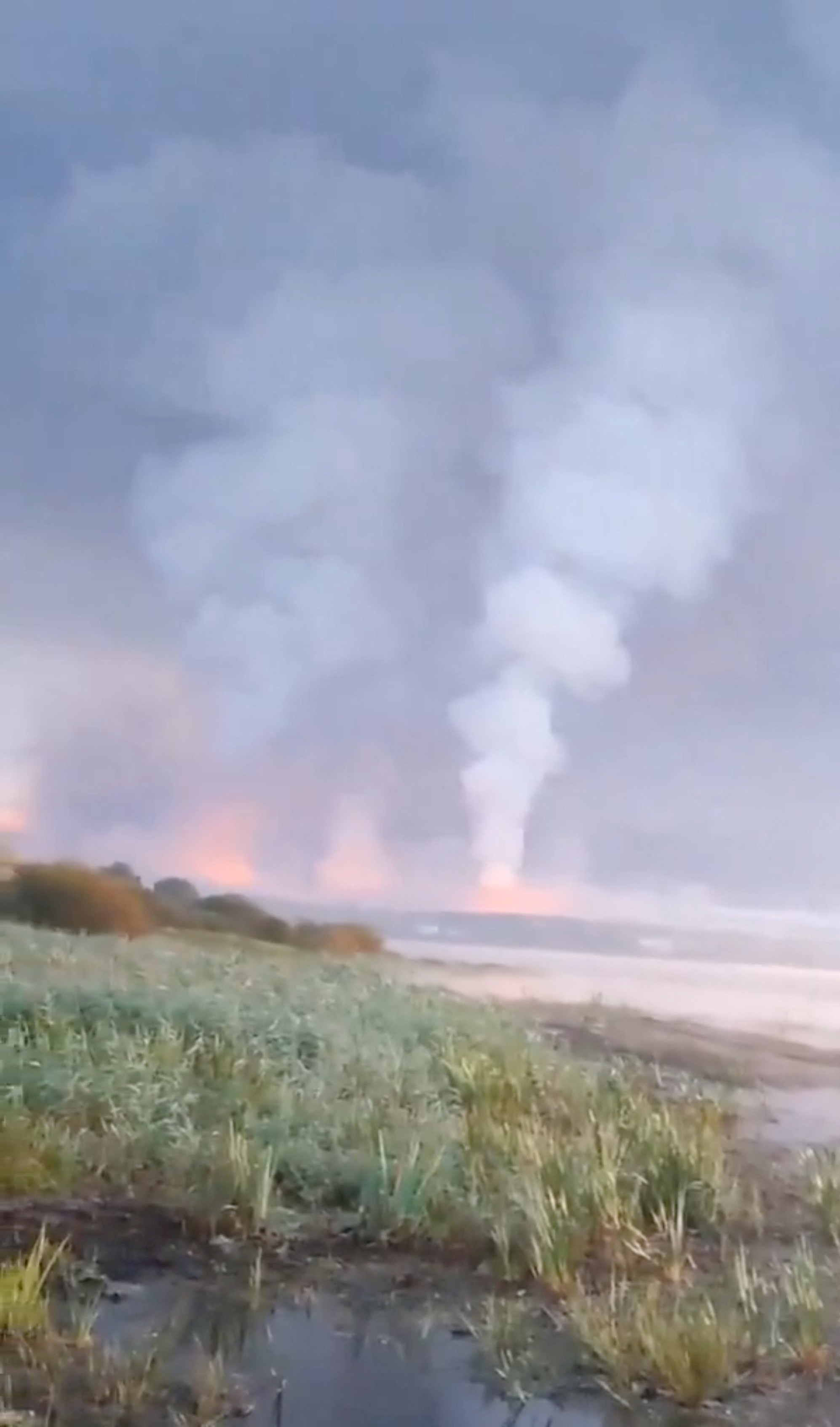 Smoke and flames rise following a Ukrainian drone attack
