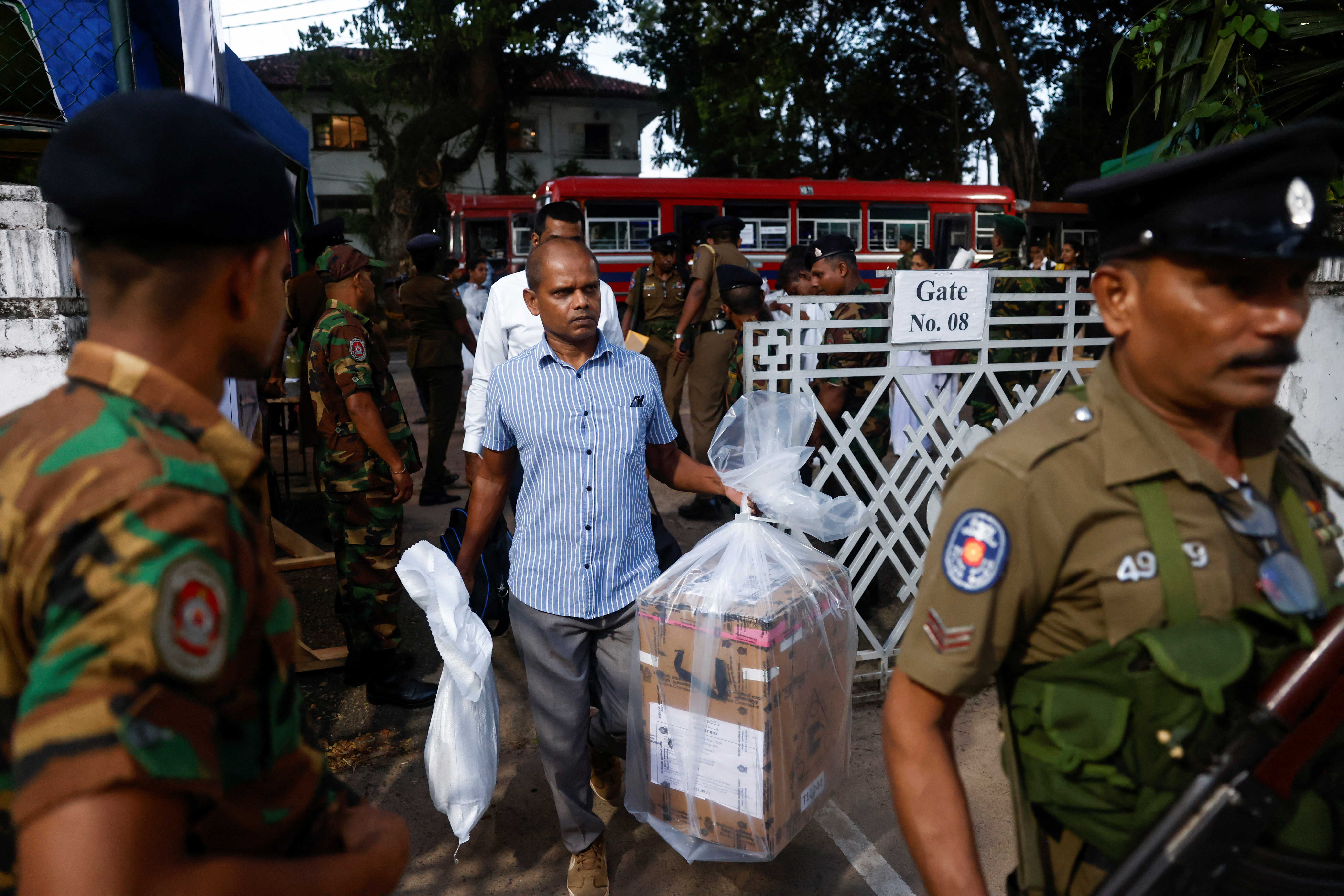 An election official carrying a ballot box in Sri Lanka