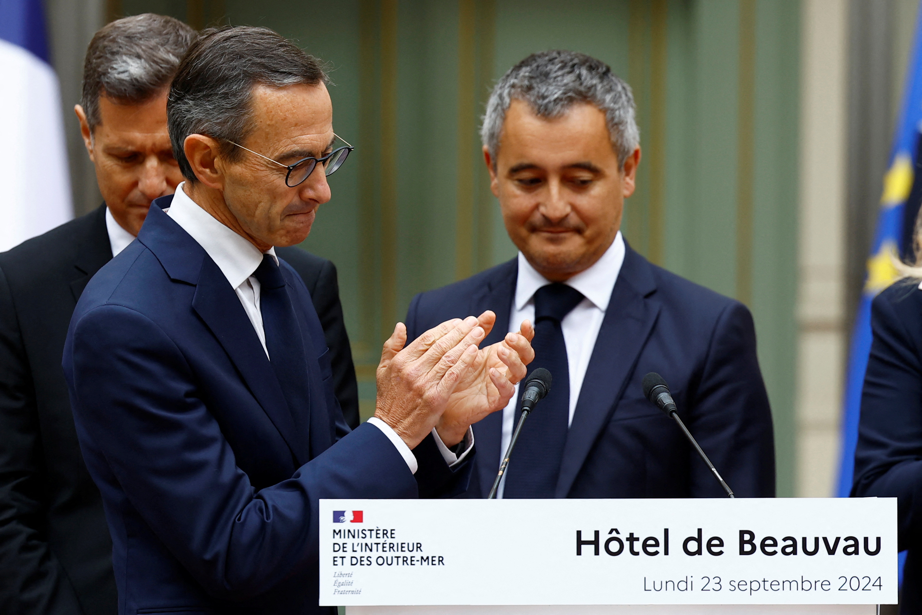 Outgoing French Interior Minister Gerald Darmanin is applauded by newly-appointed French Interior Minister Bruno Retailleau during a handover ceremony at the Interior Ministry in Paris, France, September 23, 2024. REUTERS/Stephanie Lecocq