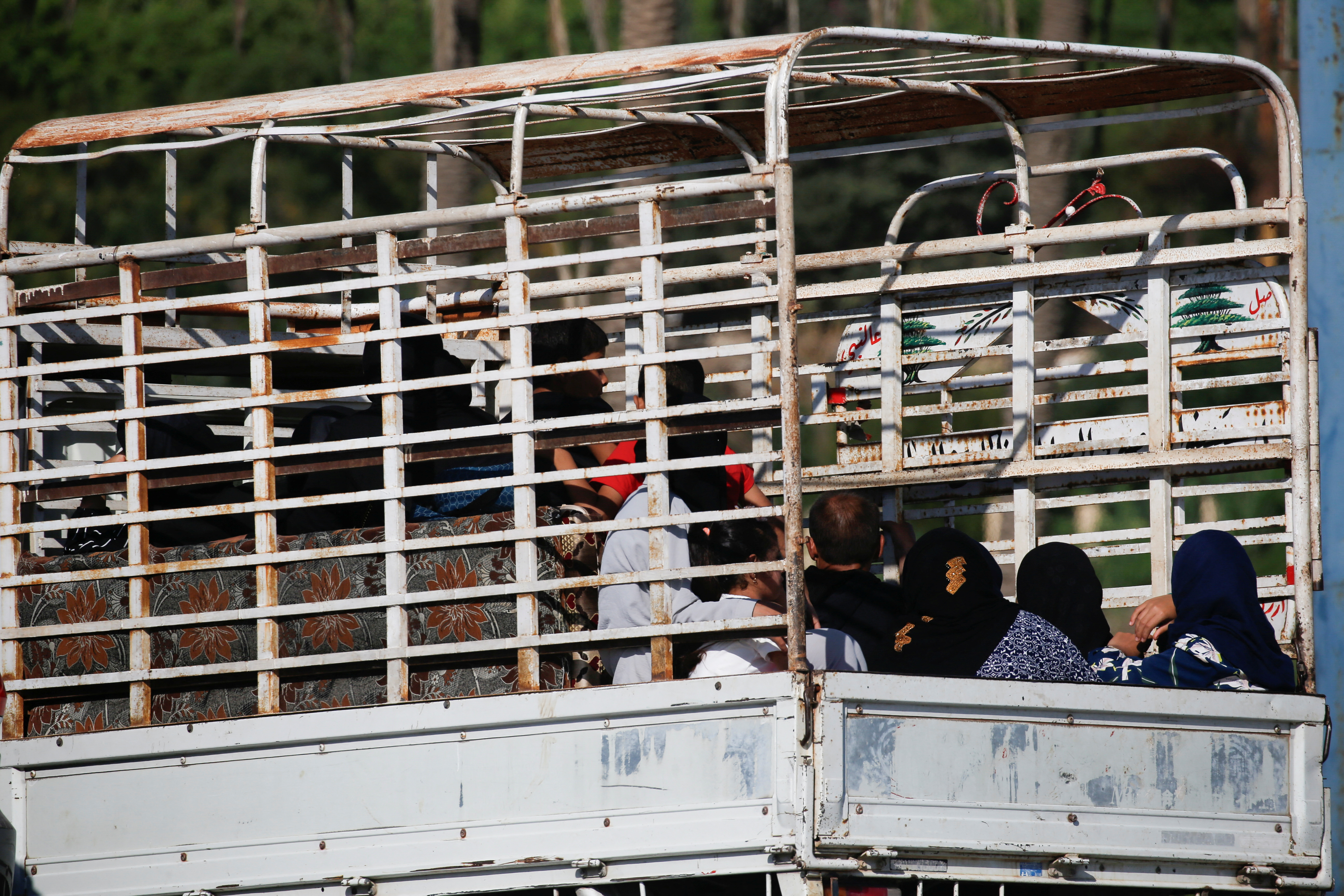 People in heavy traffic drive north from Lebanon's southern coastal city Sidon