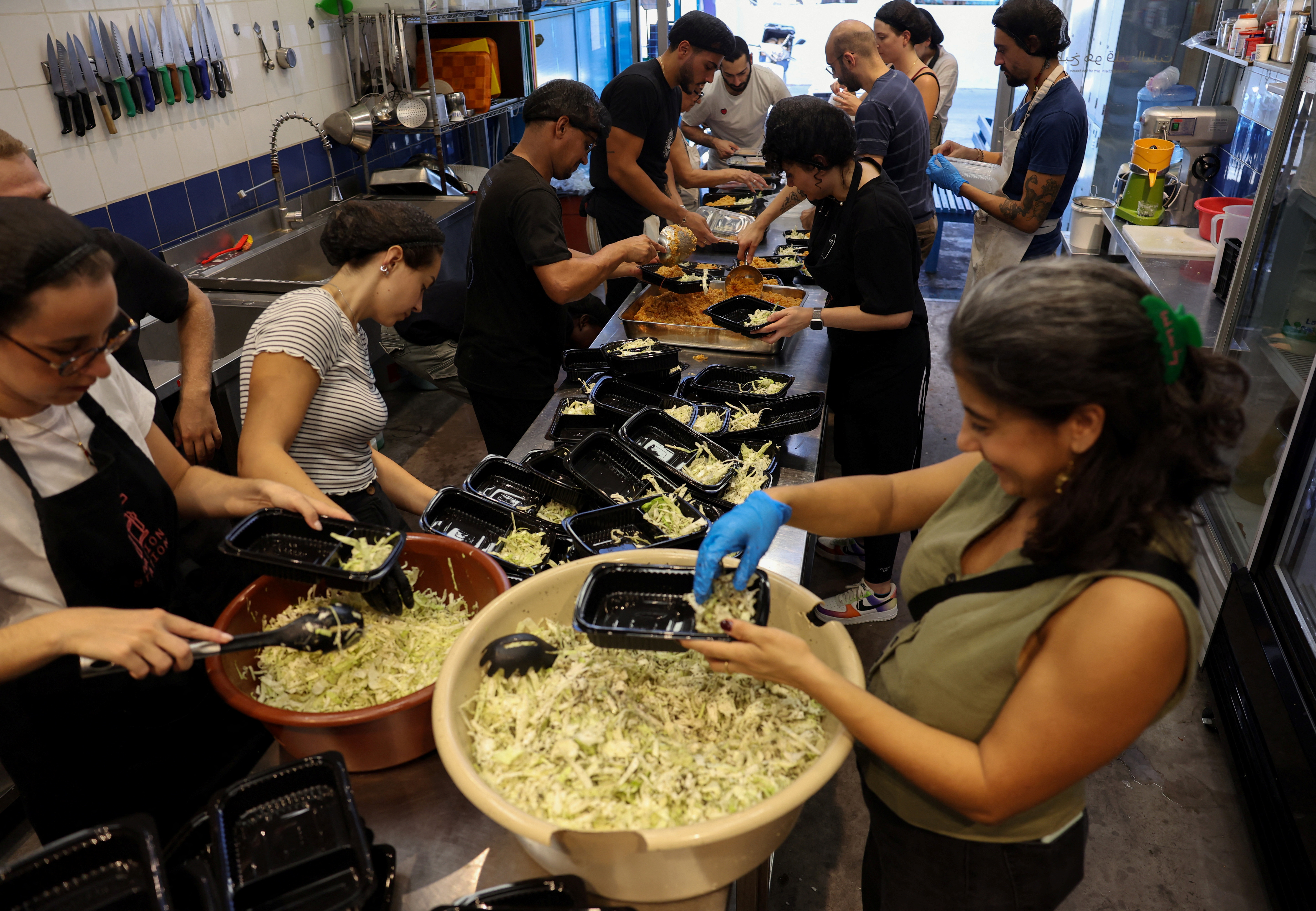 Josephine Abou Abdo, one of the founders of non-profit organisation Nation Station, prepares meals with volunteers for people displaced due to Israeli bombardment, in Beirut, Lebanon