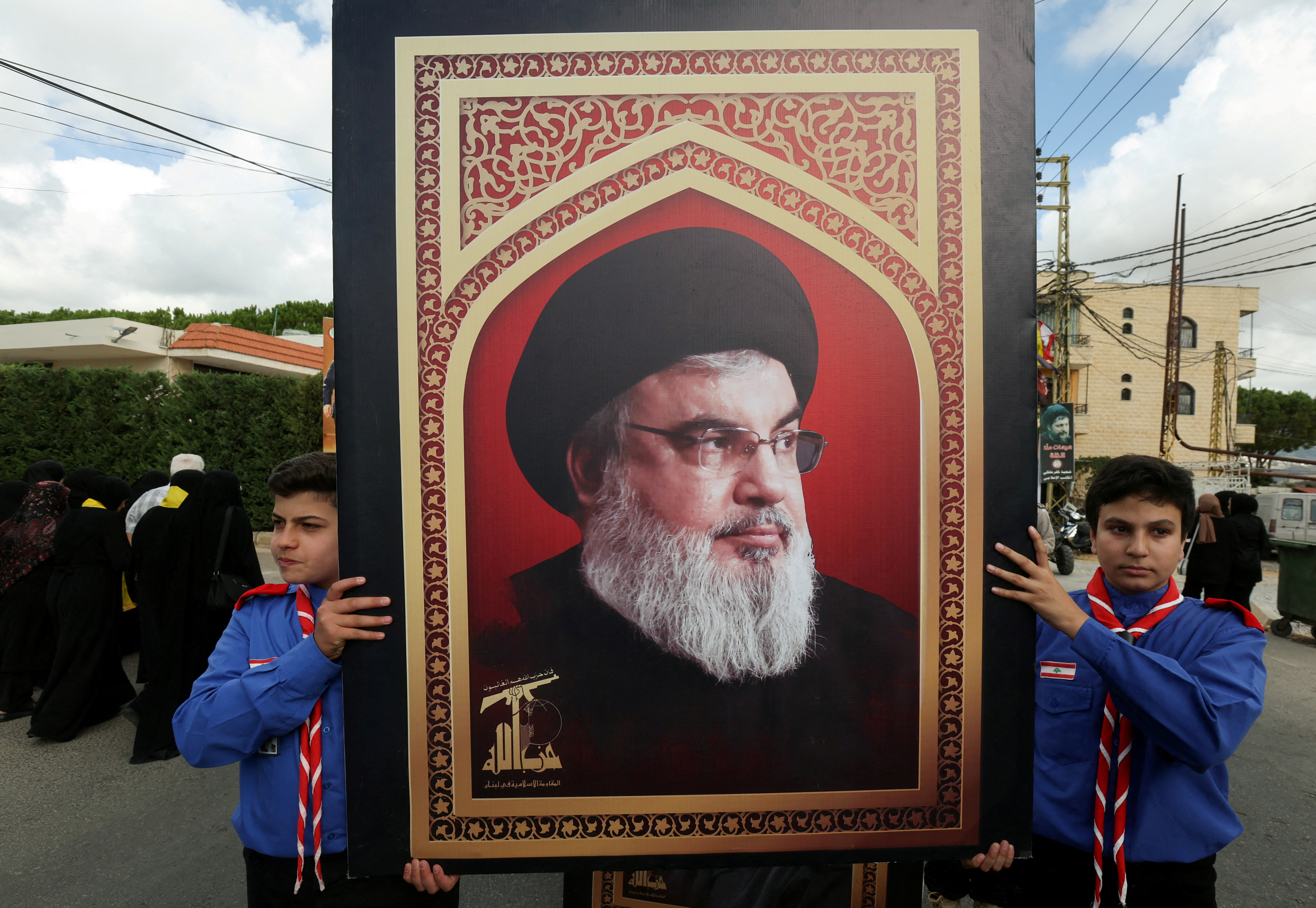 FILE PHOTO: Boys scouts carry a picture of Hezbollah leader Sayyed Hassan Nasrallah during the funeral of Hezbollah member Ali Mohamed Chalbi, after hand-held radios and pagers used by Hezbollah detonated across Lebanon, in Kfar Melki, Lebanon September 19, 2024. REUTERS/Aziz Taher/File Photo