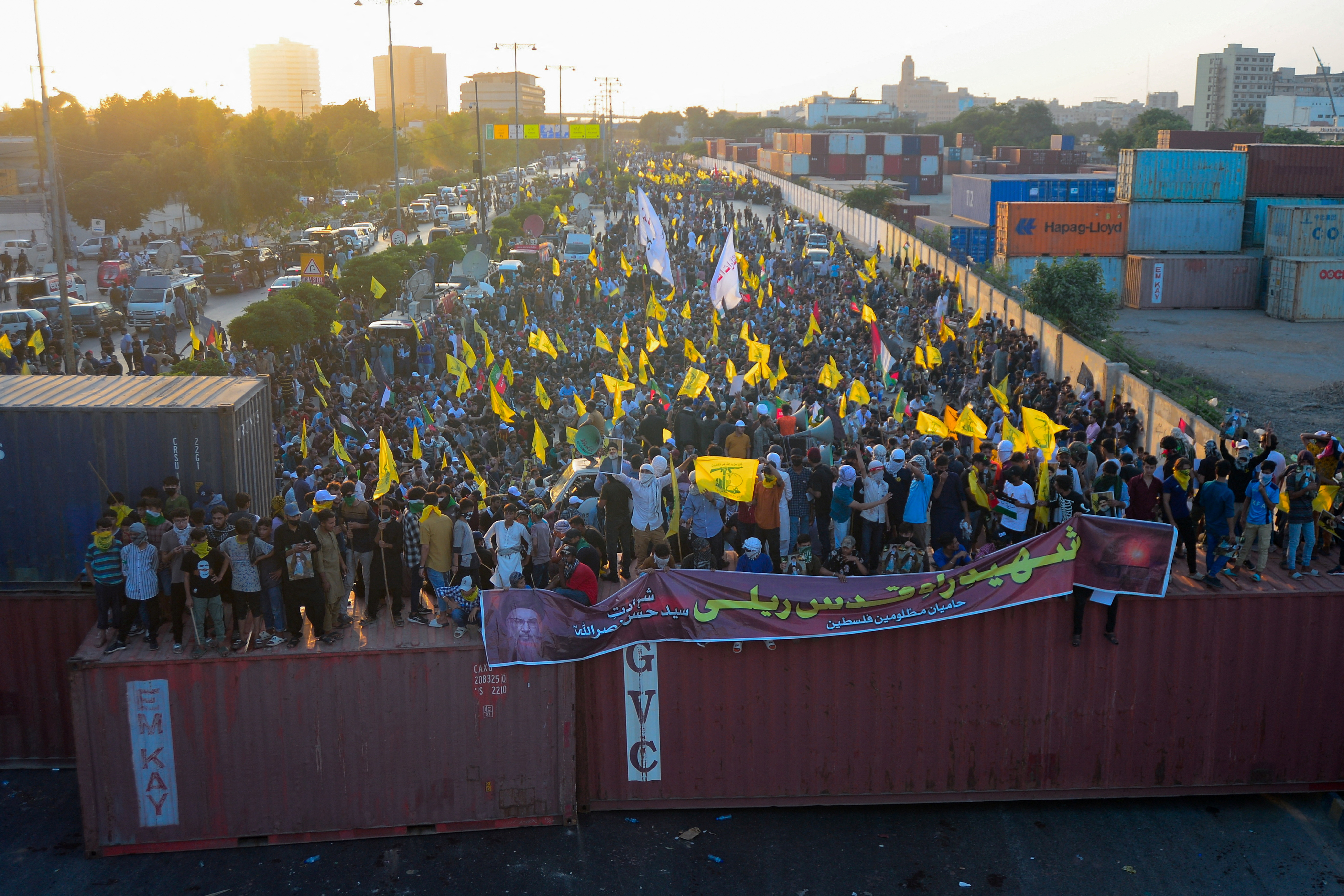 Pakistani Shi'ite Muslims carry flags as they protest the killing of Lebanon's Hezbollah leader Sayyed Hassan Nasrallah in an Israeli air strike in Beirut