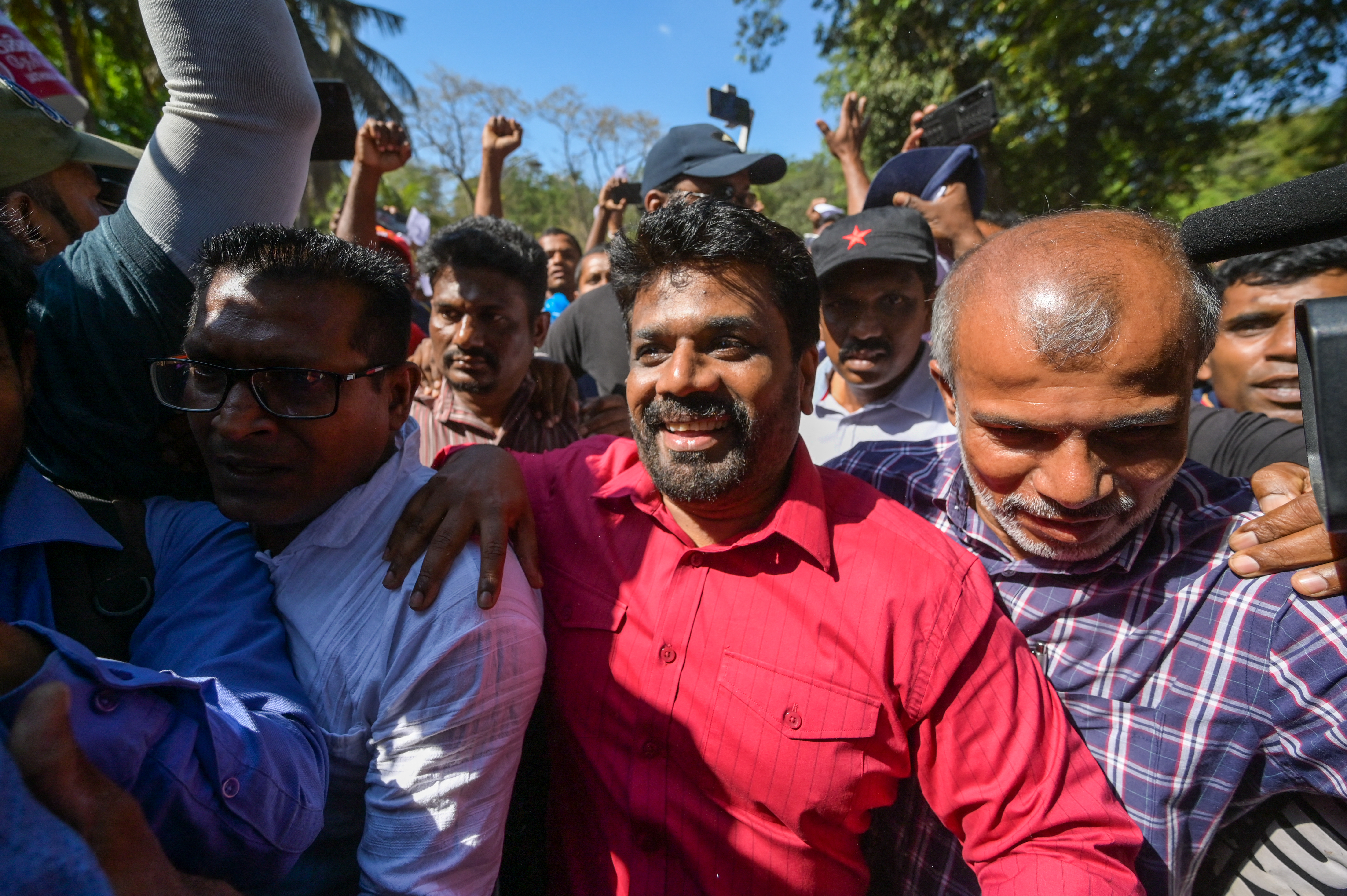 National Peoples Power (NPP) party leader Anura Kumara Dissanayake (C) takes part in a protest held to urge the government to hold local council election as scheduled in Colombo on February 26, 2023. (Photo by ISHARA S. KODIKARA / AFP)