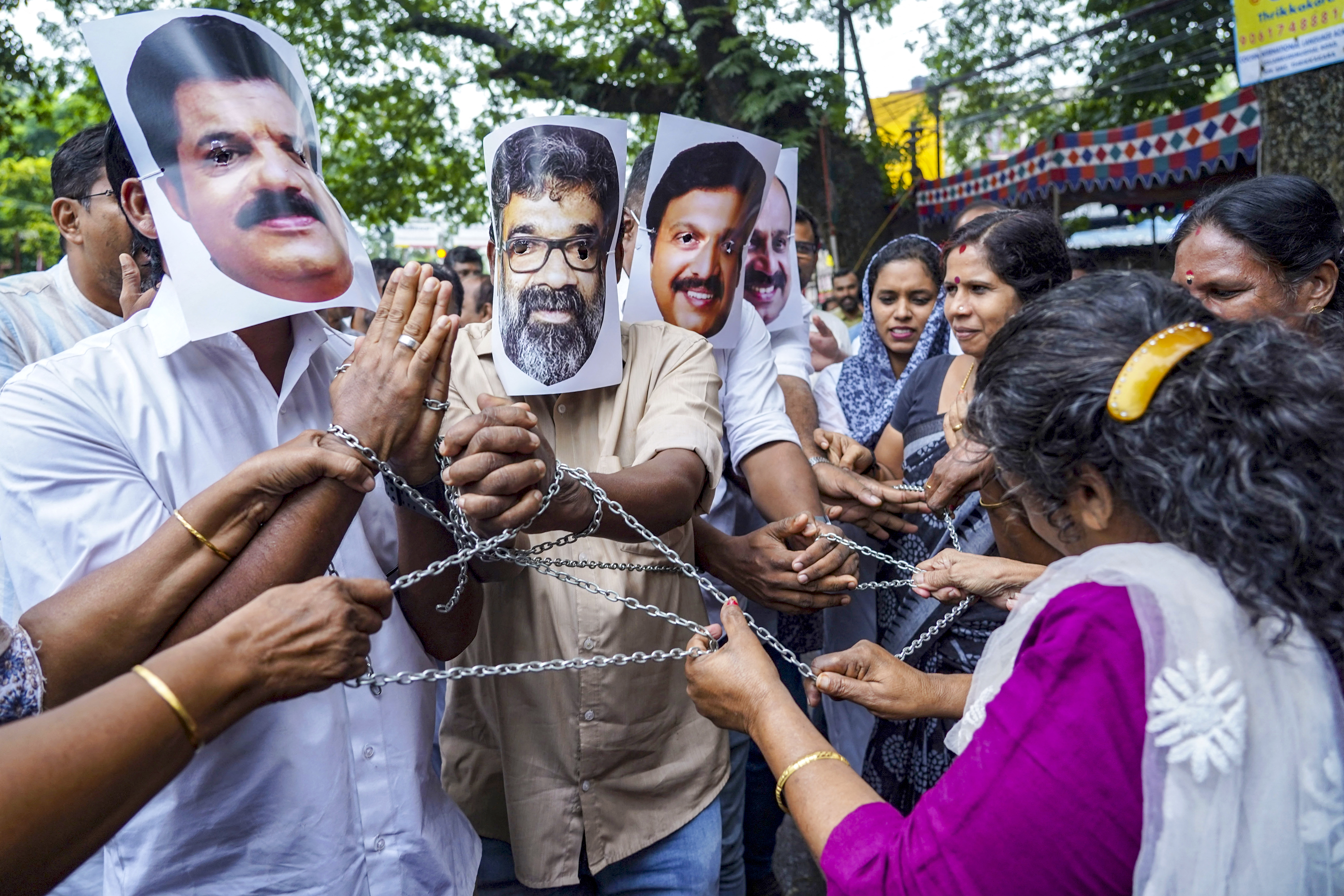 Indian National Congress (INC) party workers wear masks of celebrities from the country's Kerala-based Mollywood film industry during a protest against the government's action over alleged sexual allegations within the industry, in Kochi on August 30, 2024.