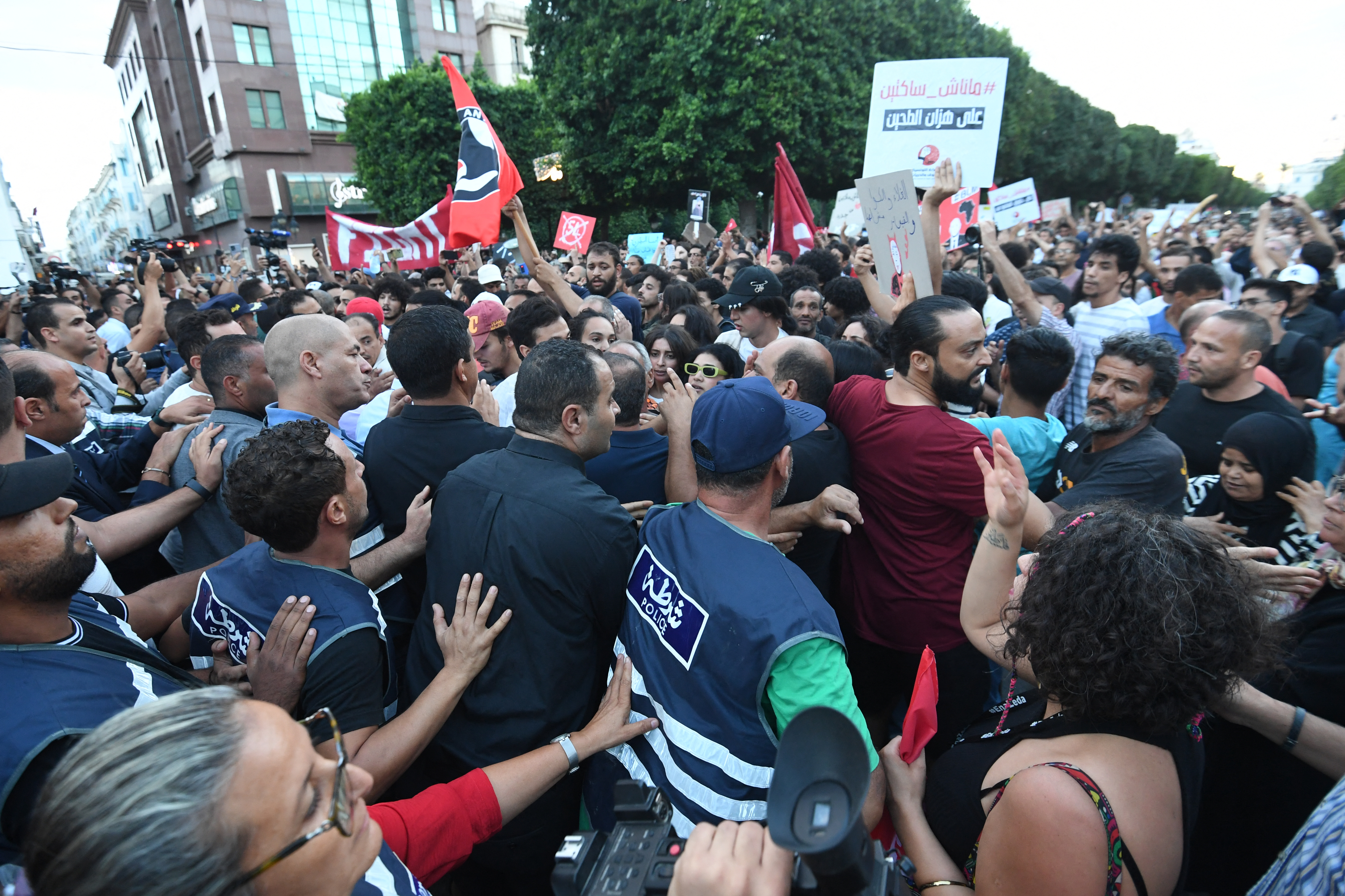 Police block the road in front of a protest denouncing the policies of the President of Tunis outside the Interior Ministry in Tunis on September 13, 2024, ahead of the upcoming Presidential Elections. (Photo by FETHI BELAID / AFP)