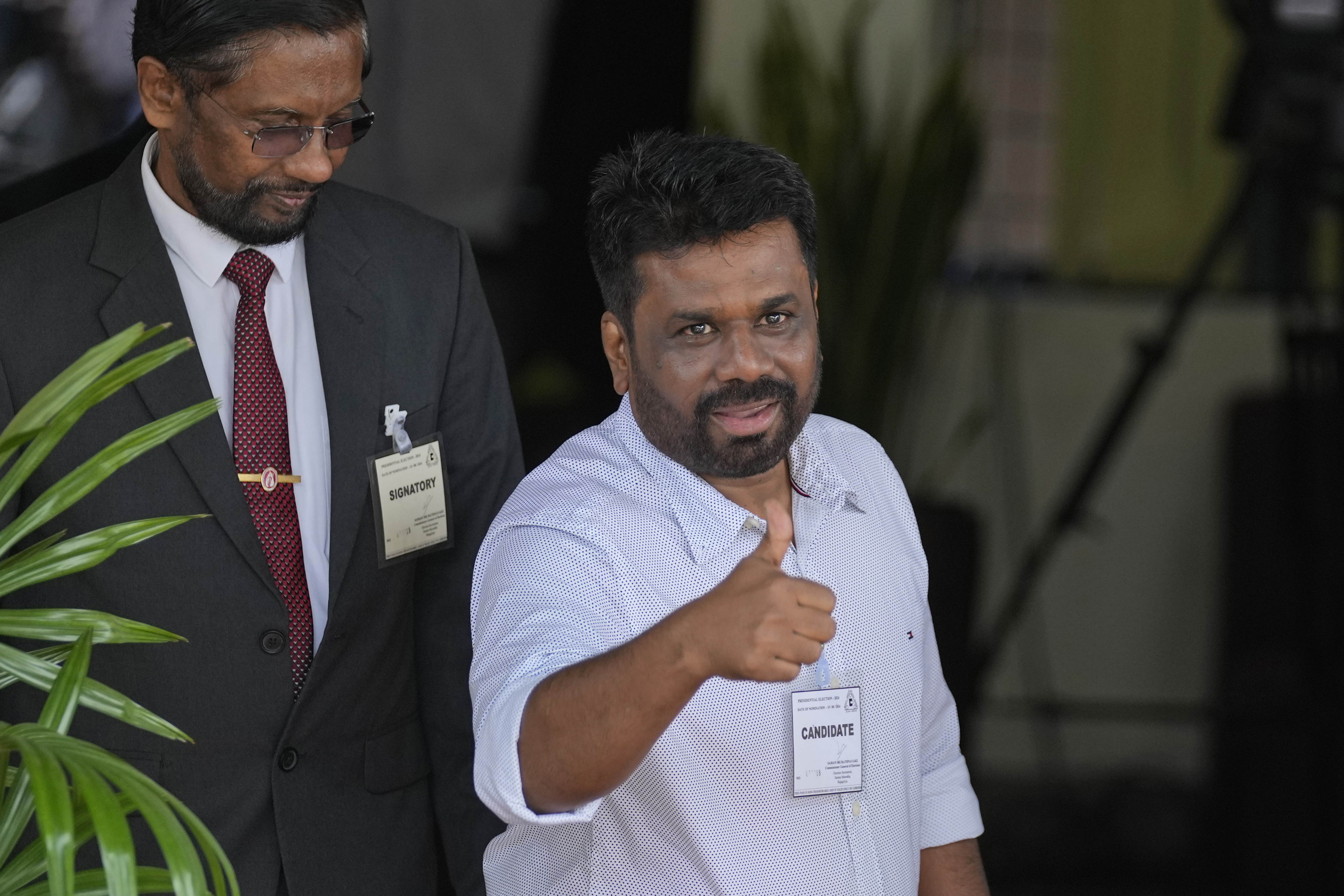Anura Kumara Dissanayake, leader of opposition political party National People's Power gestures towards media as he arrives to file nomination for the upcoming presidential election in Colombo, Sri Lanka, Thursday, Aug. 15, 2024. (AP Photo/Eranga Jayawardena)