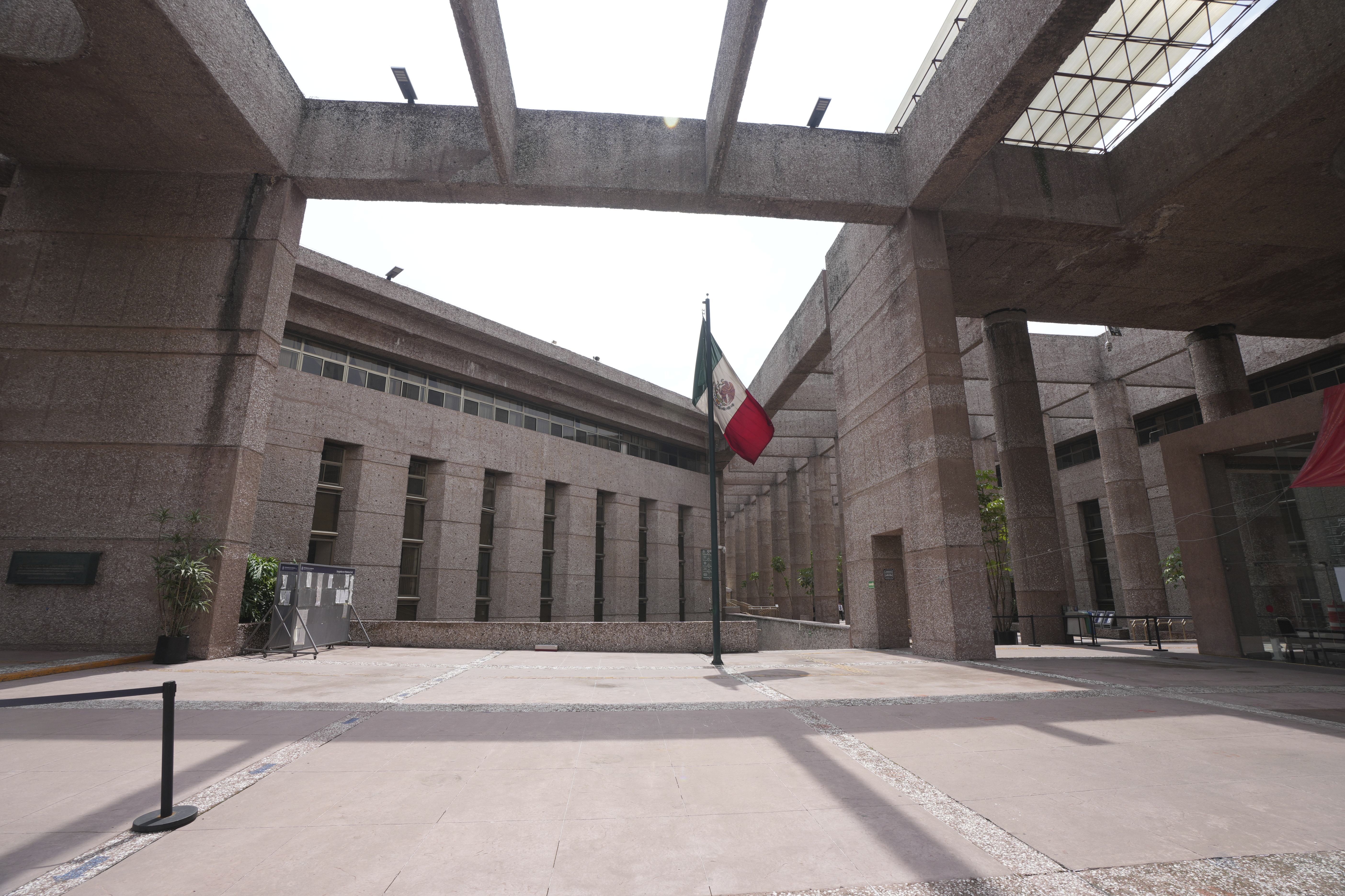 A Mexican flag stands amid the empty corridors of the federal court