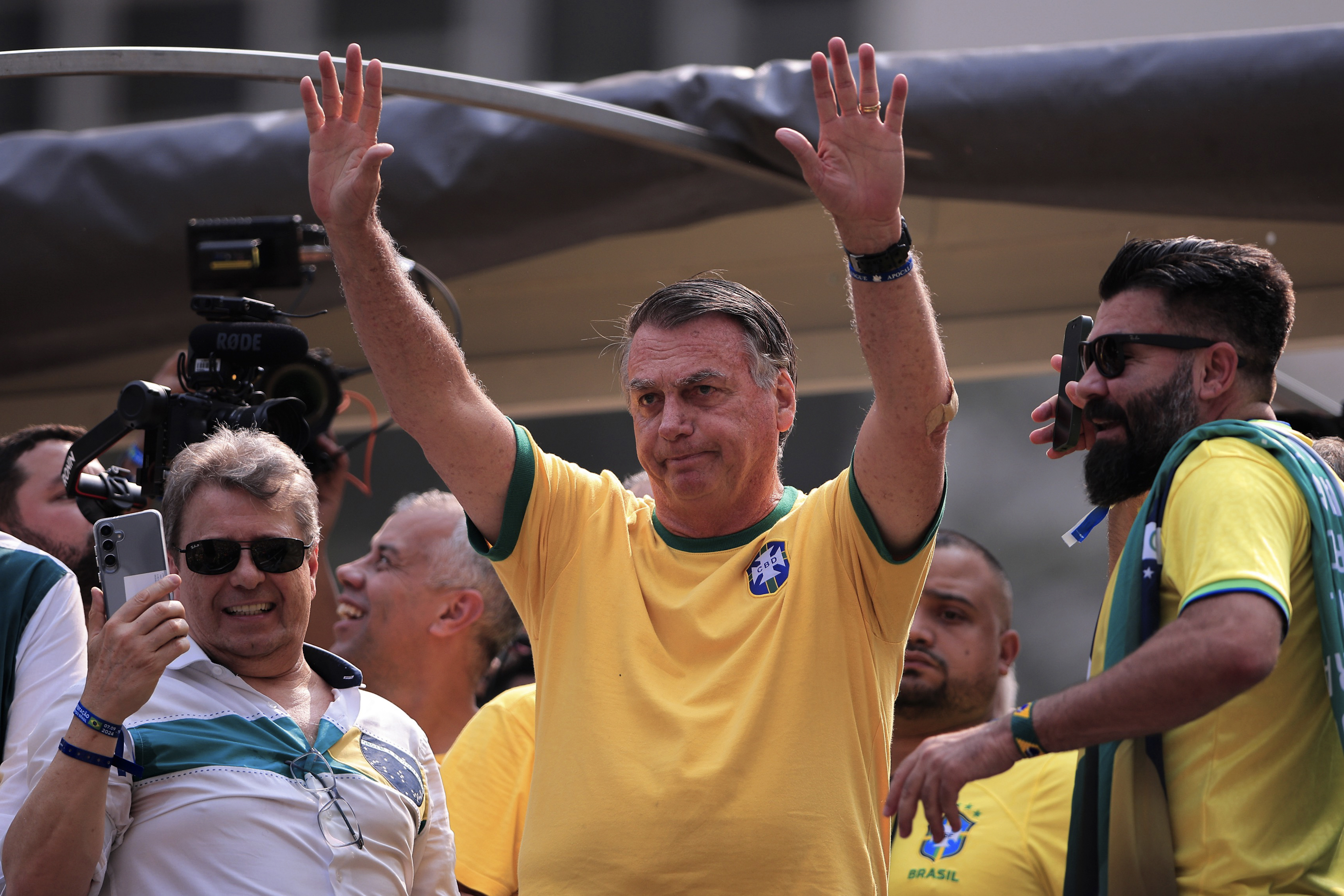 Bolsonaro extends his hands into the air to acknowledge the crowds on Brazil's Independence Day.