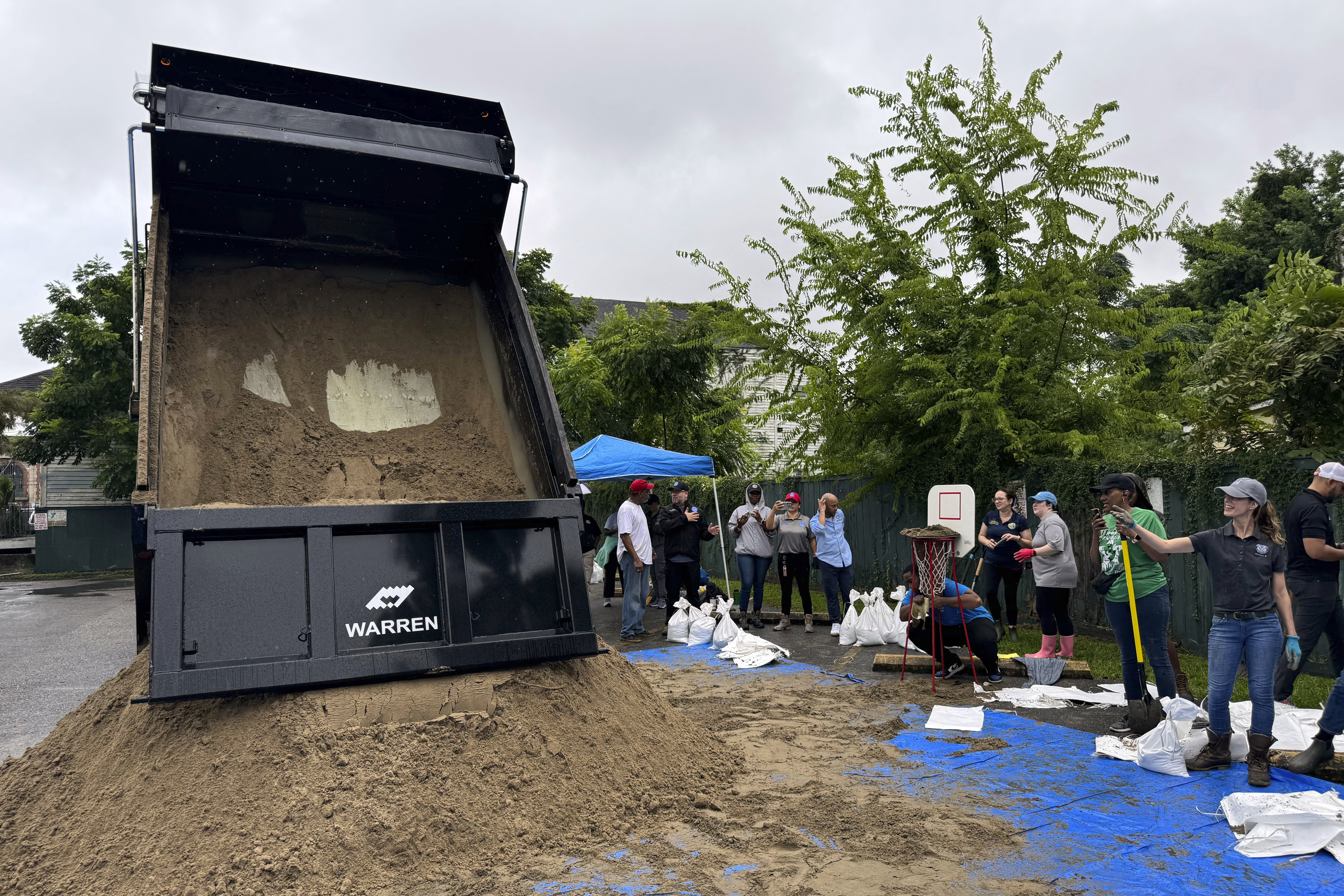 Residents fill up sand bags to protect their homes in anticipation of Tropical Storm Francine