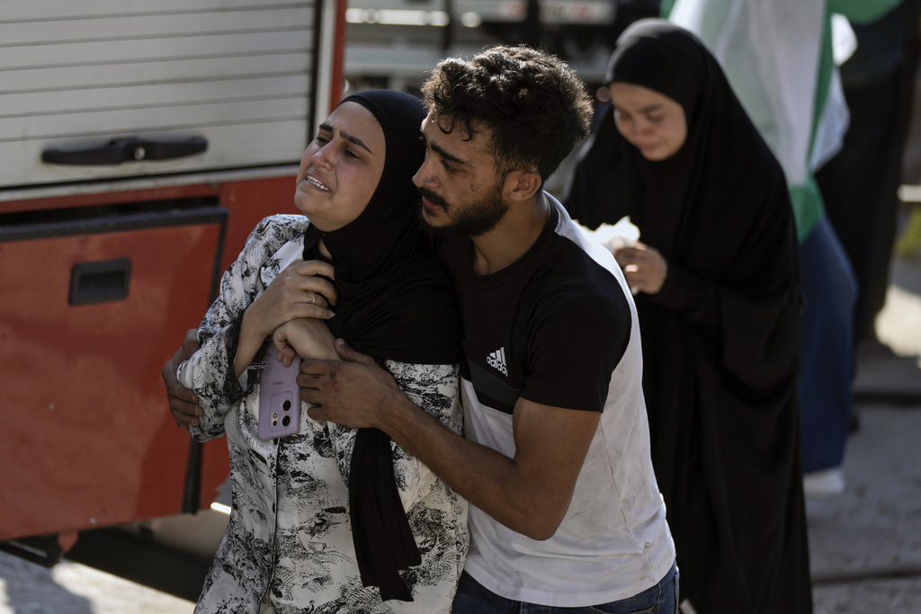 A woman grieves at the scene of an Israeli air strike in the town of Maaysrah, north of Beirut, on Wednesday [Bilal Hussein/AP Photo]