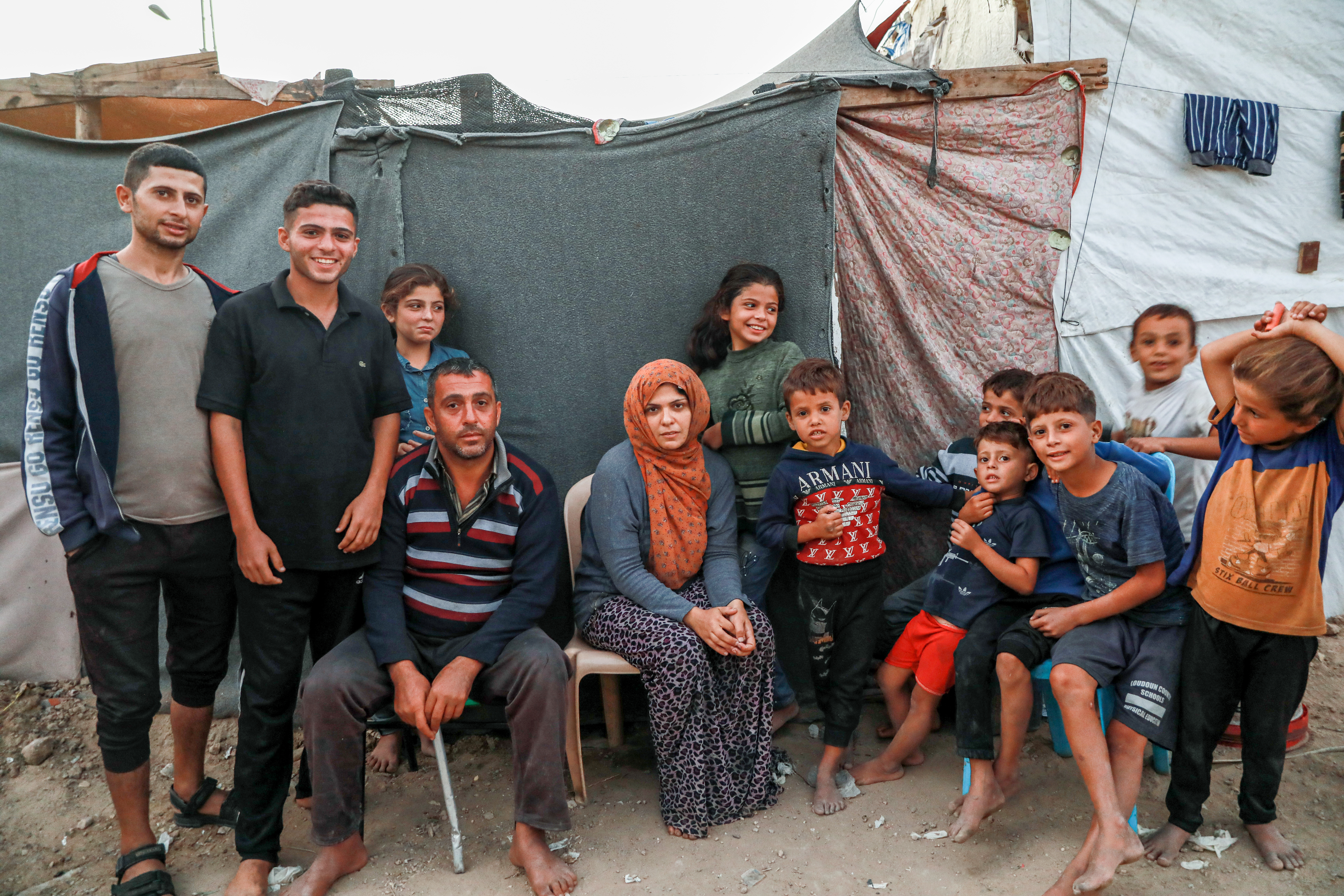 Aya Abdrabu with her family and relatives in the camp [Abdelhakim Abu Riash/Al Jazeera]