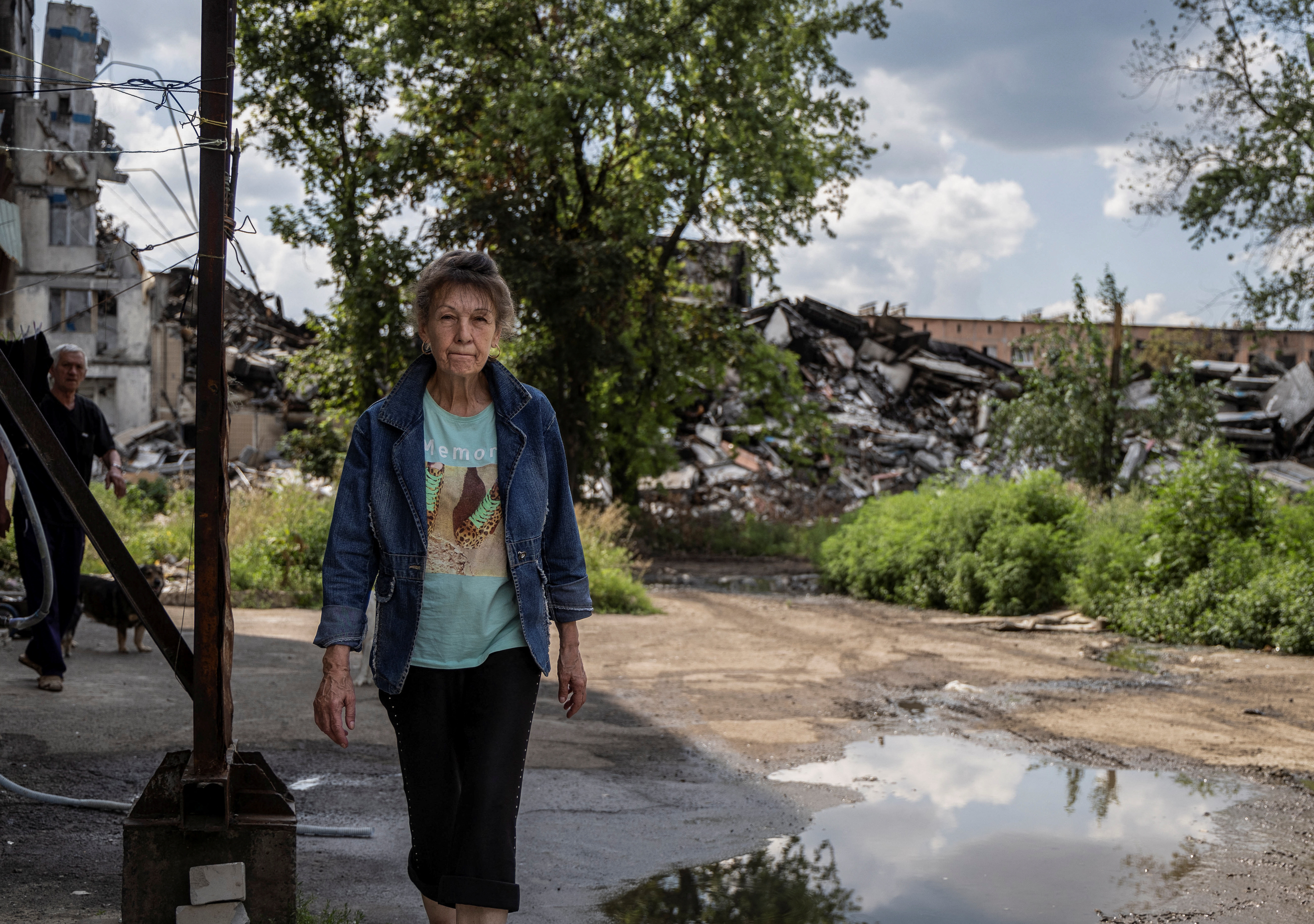 A local resident walks near buildings damaged by a Russian military strike, as Russia's attack on Ukraine continues, in the front line city of Vuhledar in Donetsk region, Ukraine August 4, 2023. REUTERS/Alex Babenko
