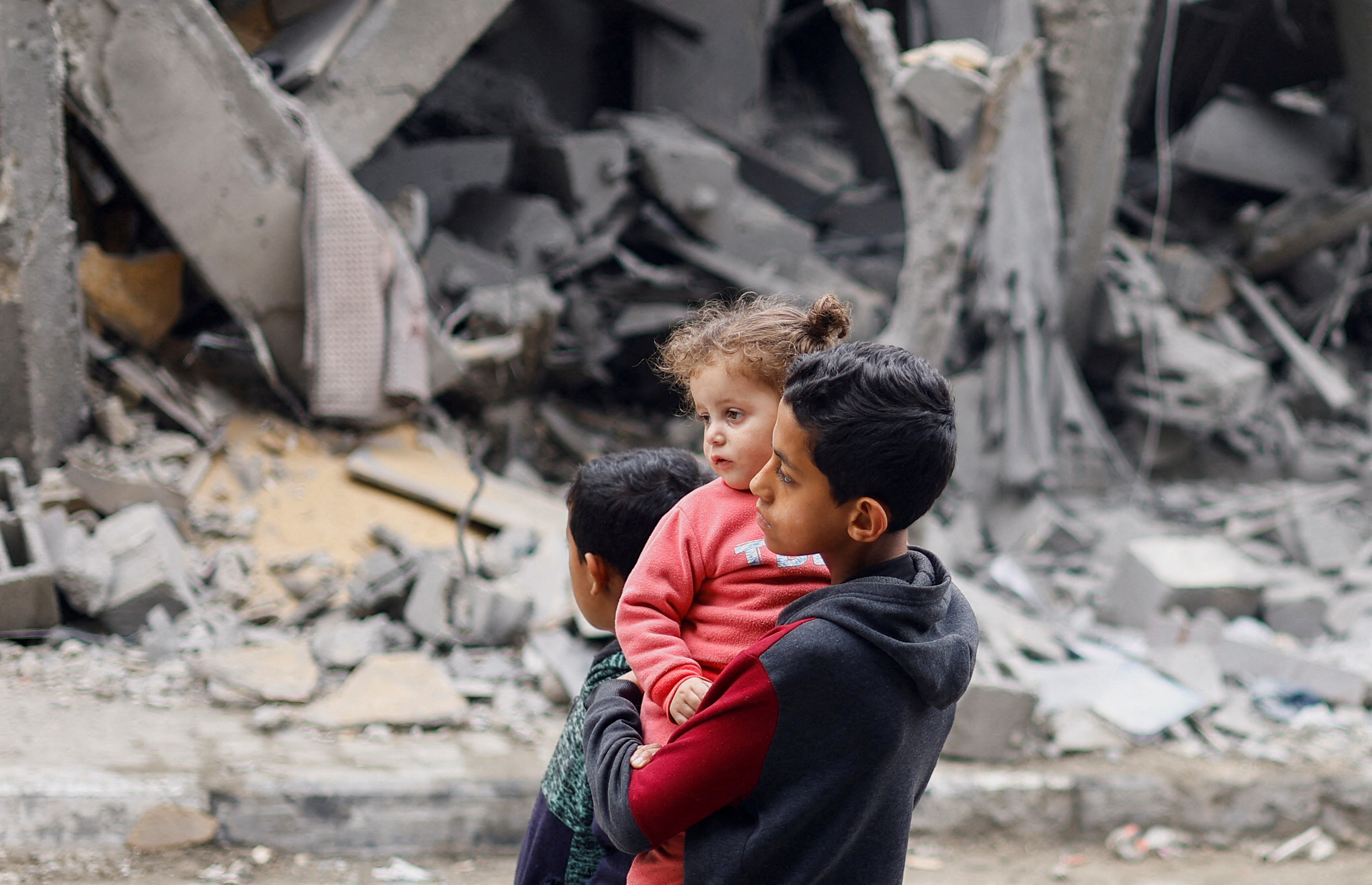 Palestinian children react near the site of an Israeli strike on a house, amid the ongoing conflict between Israel and the Palestinian Islamist group Hamas, in Rafah, in the southern Gaza Strip, March 24, 2024.