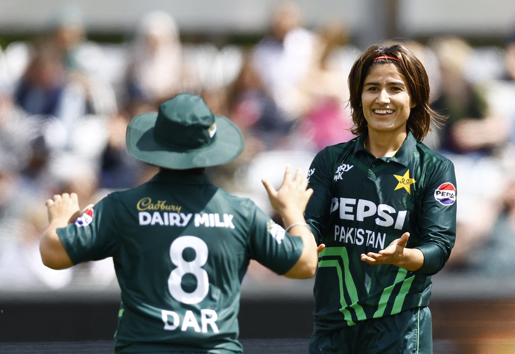 Cricket - Women's Third One Day International - England v Pakistan - County Cricket Ground, Chelmsford, Britain - May 29, 2024 Pakistan's Diana Baig celebrates with Nida Dar after taking the wicket of England's Maia Bouchier, caught out by Fatima Sana Action Images via Reuters/Peter Cziborra