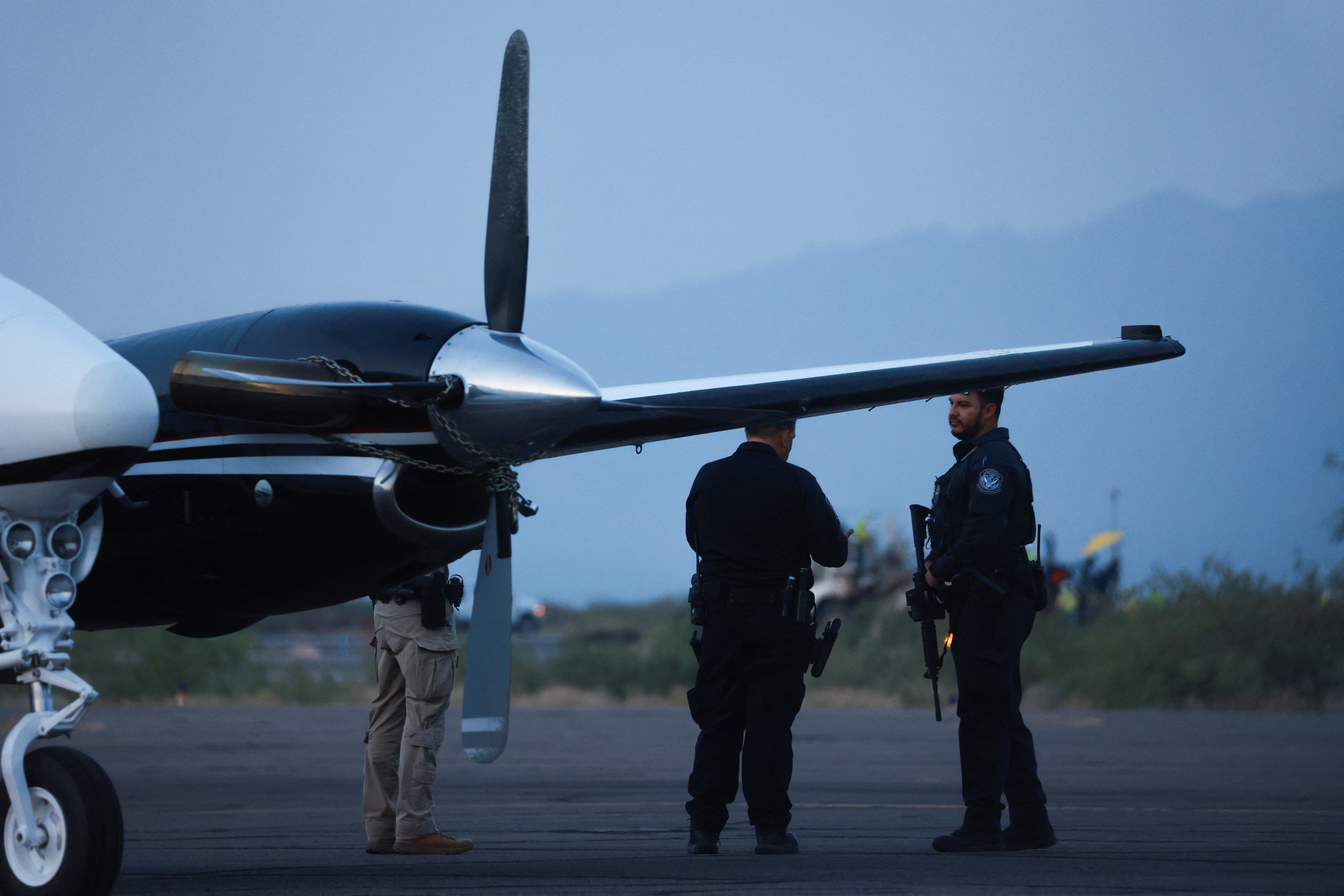 CBP agents stand by a plane believed to have carried Mexican drug lord Ismael "El Mayo" Zambada and Joaquin Guzman Lopez, the son of Zambada's former partner, Joaquin "El Chapo" Guzman, who were arrested in El Paso, Texas, is seen on the tarmac of the Dona Ana County private airport, in Santa Teresa, New Mexico, U.S., July 25, 2024. REUTERS/Jose Luis Gonzalez
