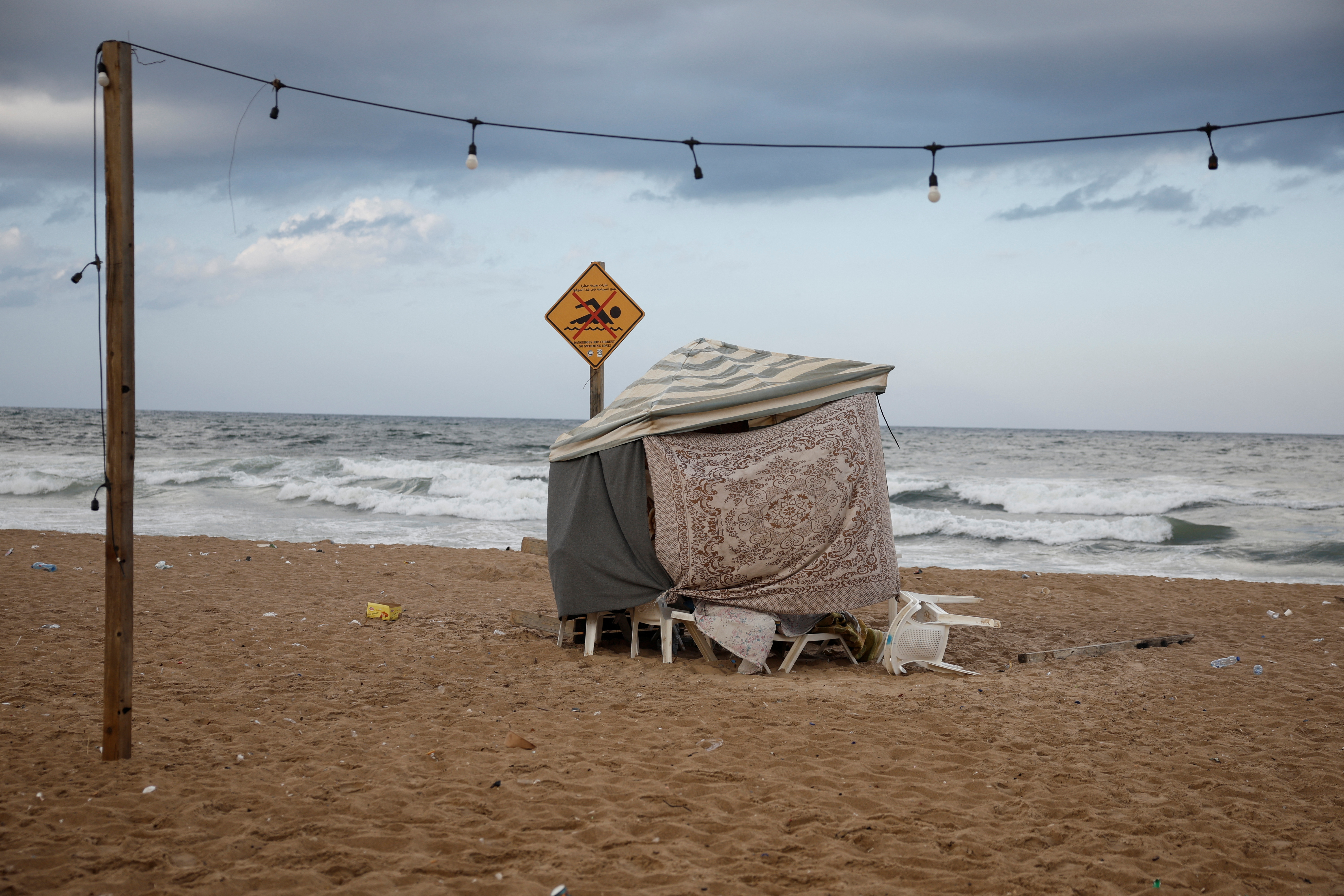 Displaced children play at a makeshift encampment where scores of displaced people live, amid cross-border hostilities between Hezbollah and Israeli forces, at a beach in Beirut, Lebanon, October 1
