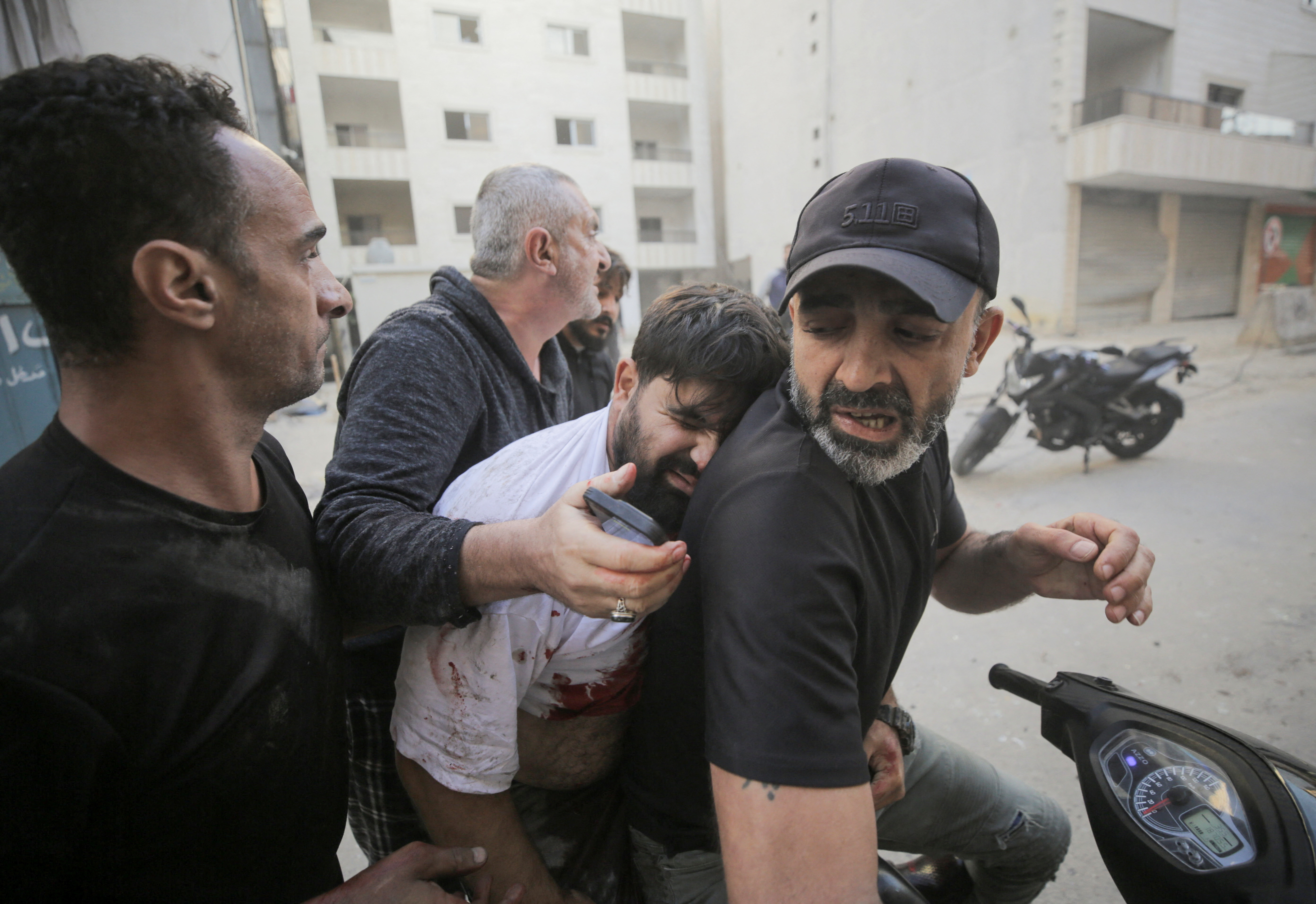 People evacuate a wounded man, after an Israeli strike on the Mreijeh neighbourhood in Beirut's southern suburbs, amid cross-border hostilities between Hezbollah and Israel, in Beirut, Lebanon October 4