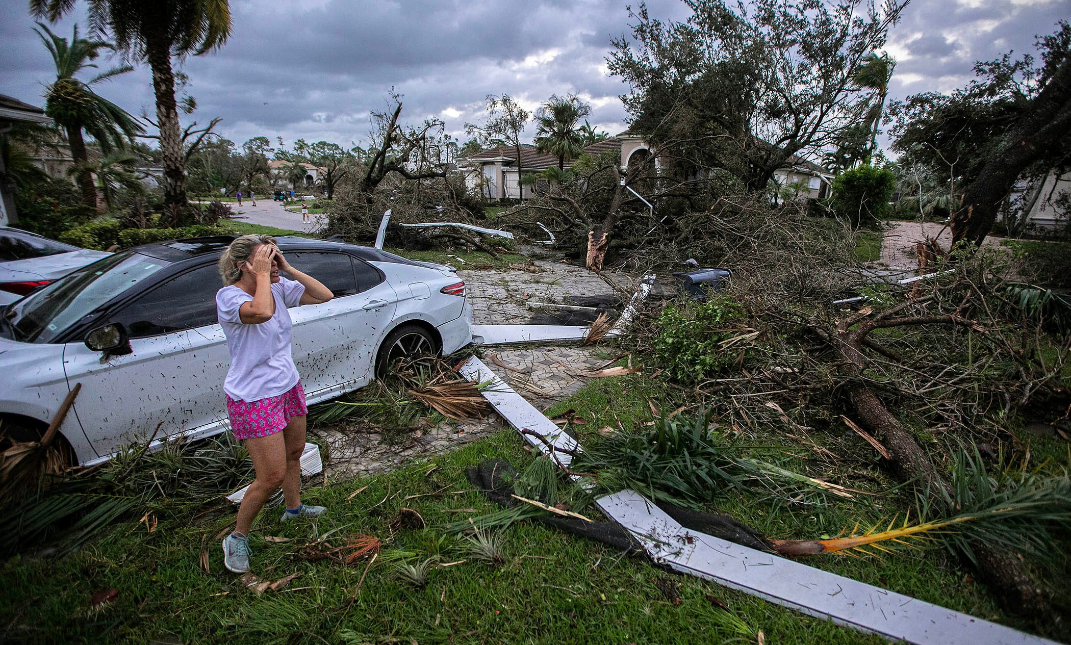 Marie Cook reacts to the damage to her home in the Binks Estates community after a tornado formed by Hurricane Milton touched down striking homes in The Preserve and Binks Estate among others in its path in Wellington, Florida, U.S. October 9