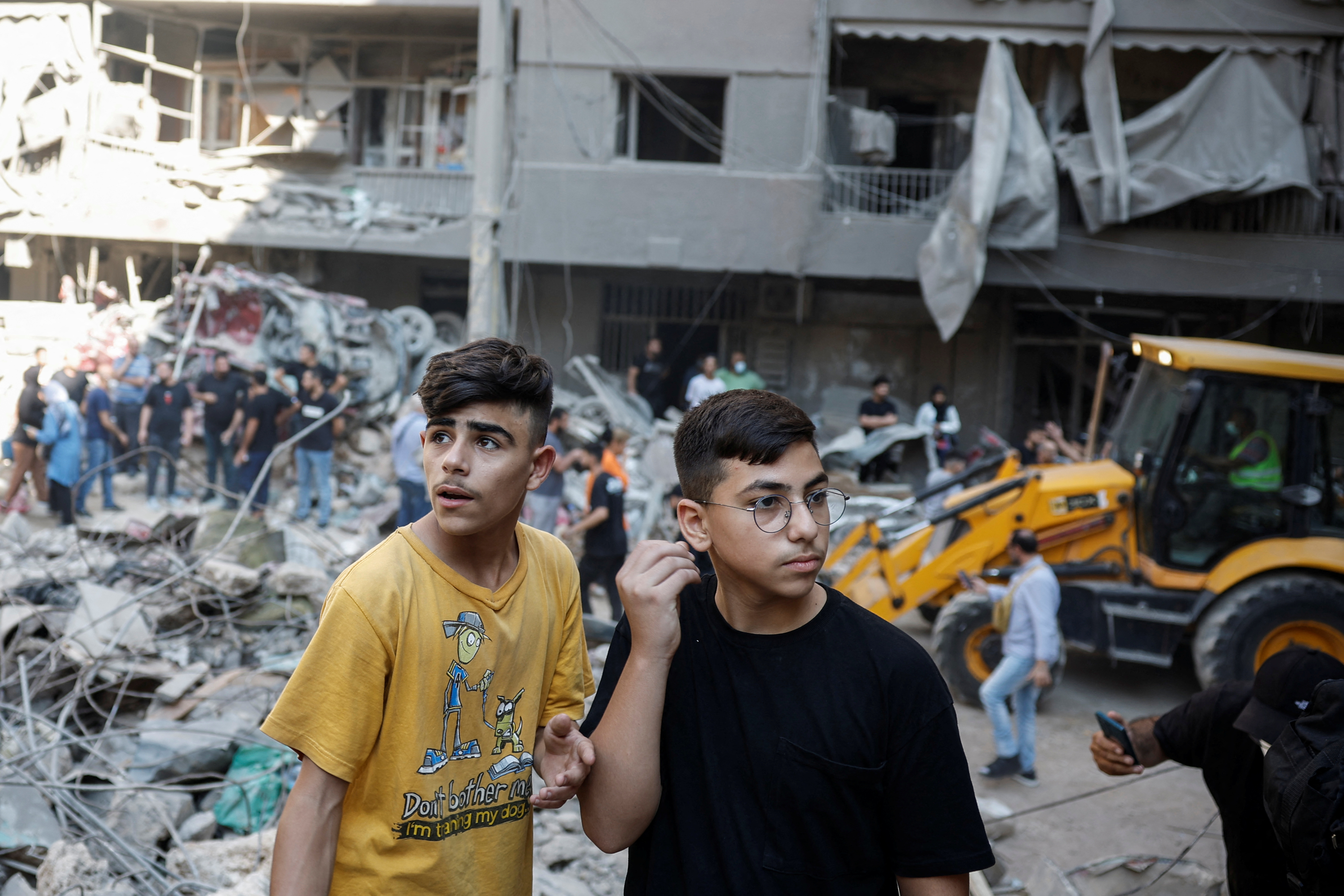 Boys look at the damage at the site of an Israeli air strike, amid ongoing hostilities between Hezbollah and Israeli forces, in Beirut, Lebanon, October 11
