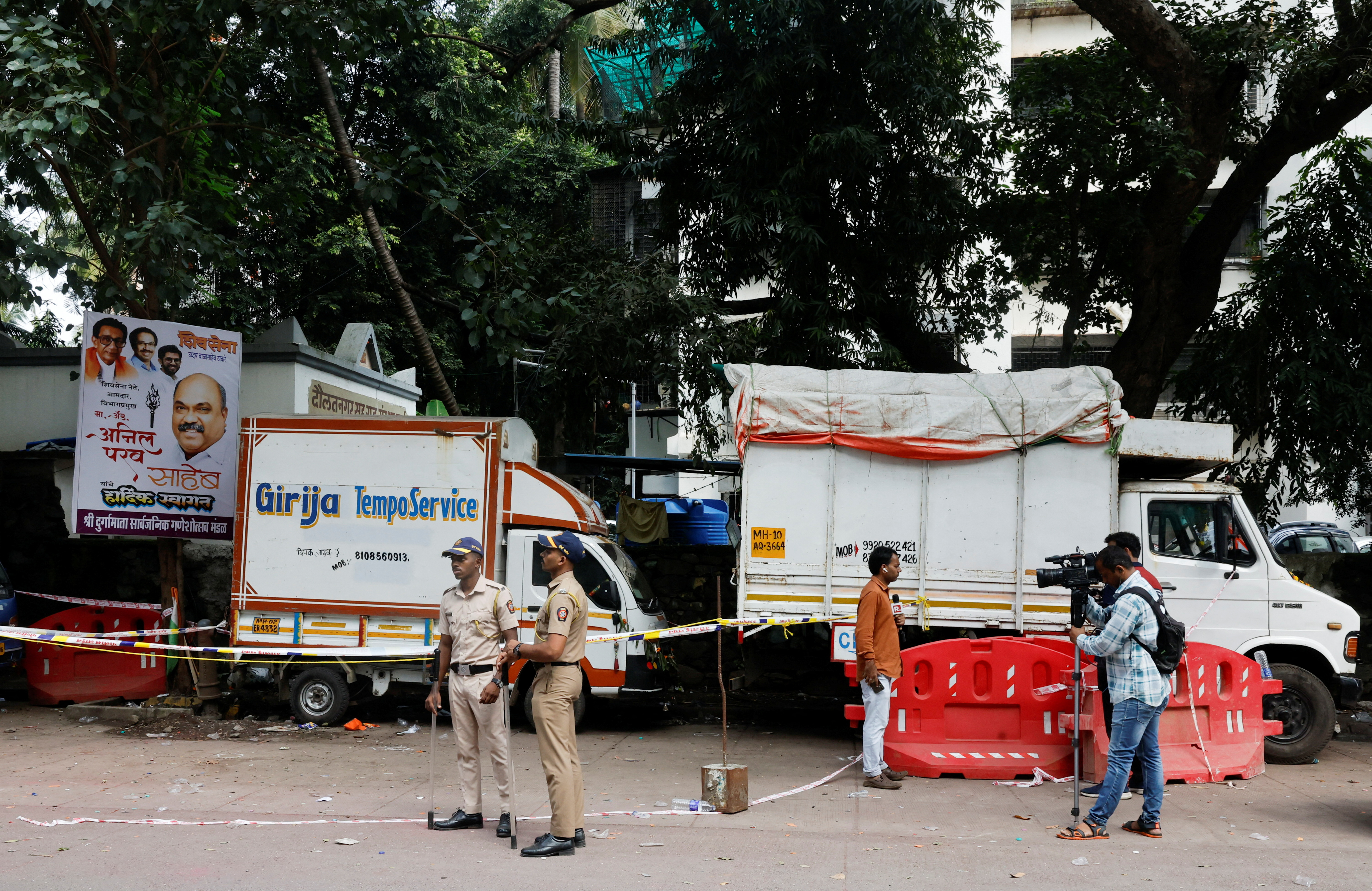 Police officers and media stand at a crime scene where Nationalist Congress Party (NCP) politician Baba Siddique was shot dead in Mumbai, India, October 13, 2024.