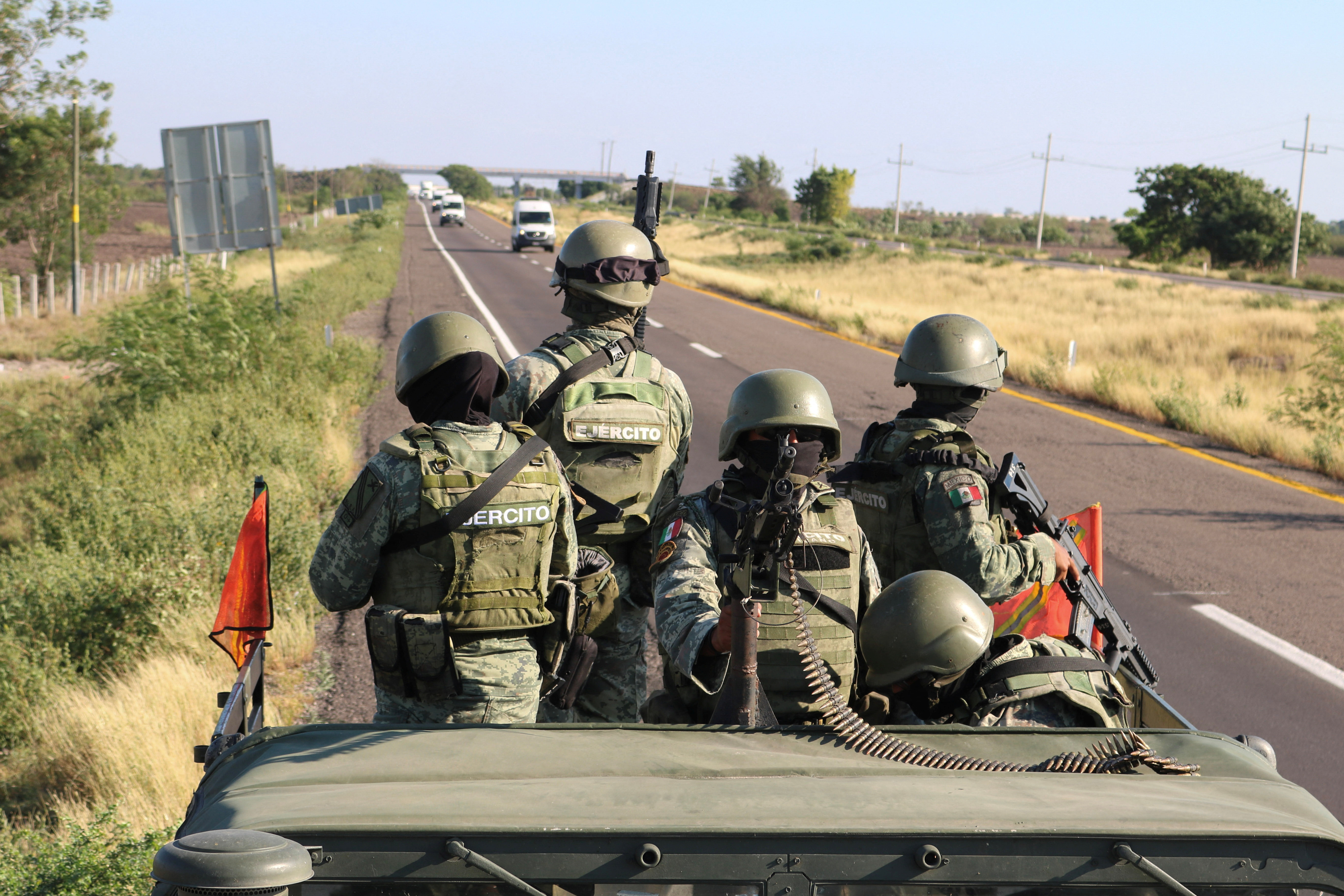 Soldiers stand guard on a highway after Mexico's military deployed additional troops to the violence-stricken state of Sinaloa over the weekend, in Culiacan, Mexico