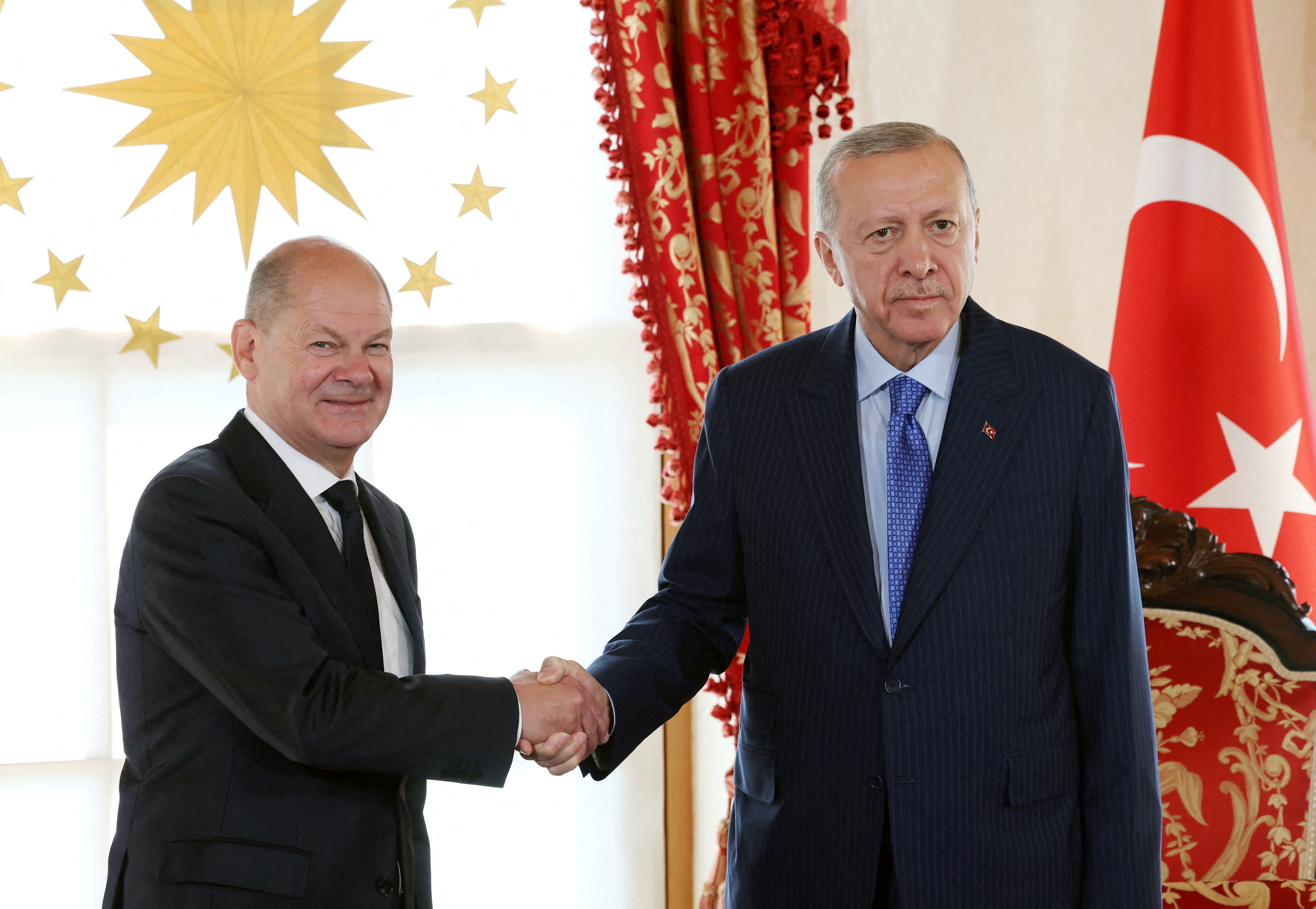 Turkish President Tayyip Erdogan and German Chancellor Olaf Scholz shake hands before their meeting in Istanbul, Turkey October 19, 2024. Mustafa Kamaci/Presidential Press Office/Handout via REUTERS ATTENTION EDITORS - THIS PICTURE WAS PROVIDED BY A THIRD PARTY. NO RESALES. NO ARCHIVES. TPX IMAGES OF THE DAY