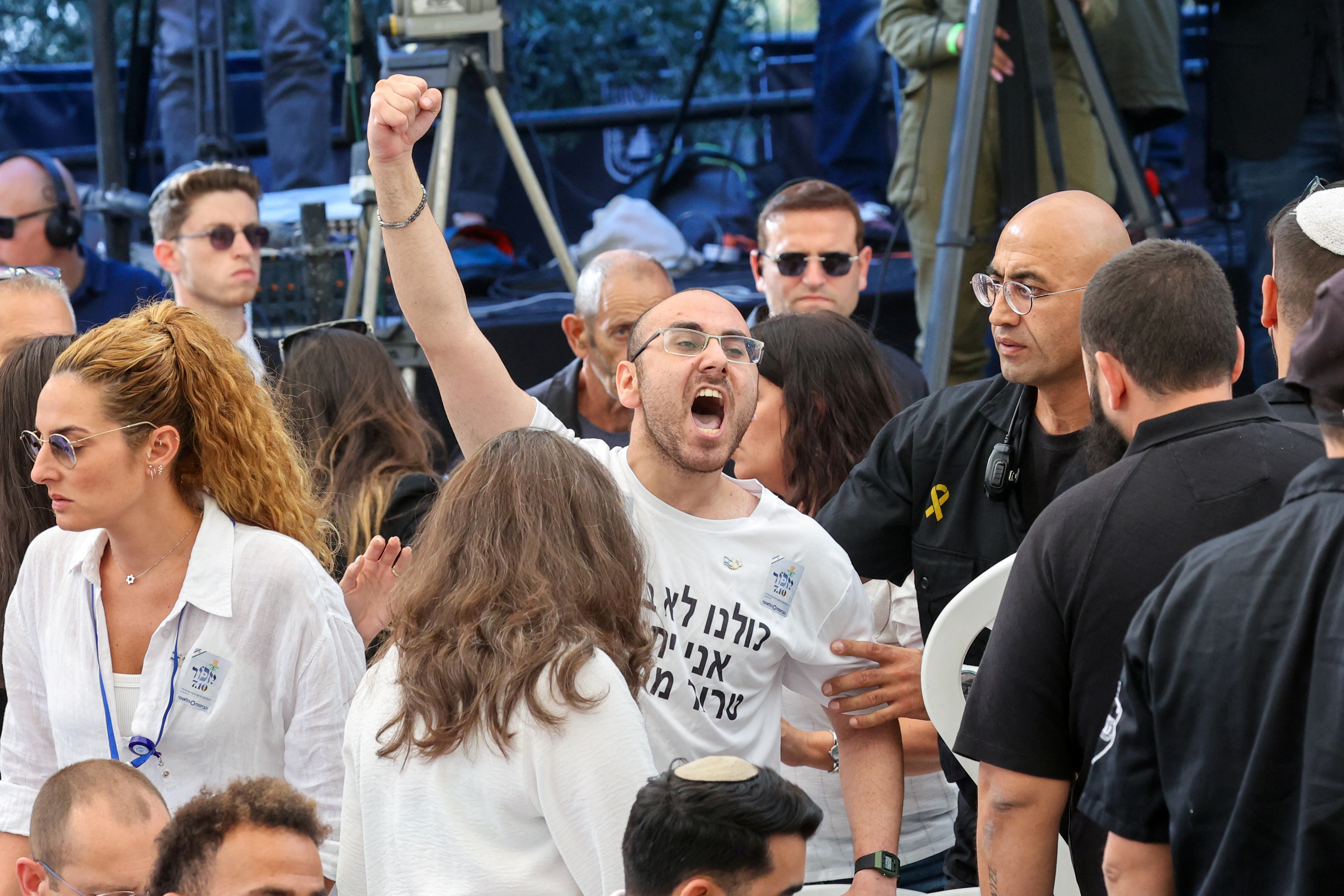 A man shouts as Israeli Prime Minister Benjamin Netanyahu speaks during a memorial ceremony