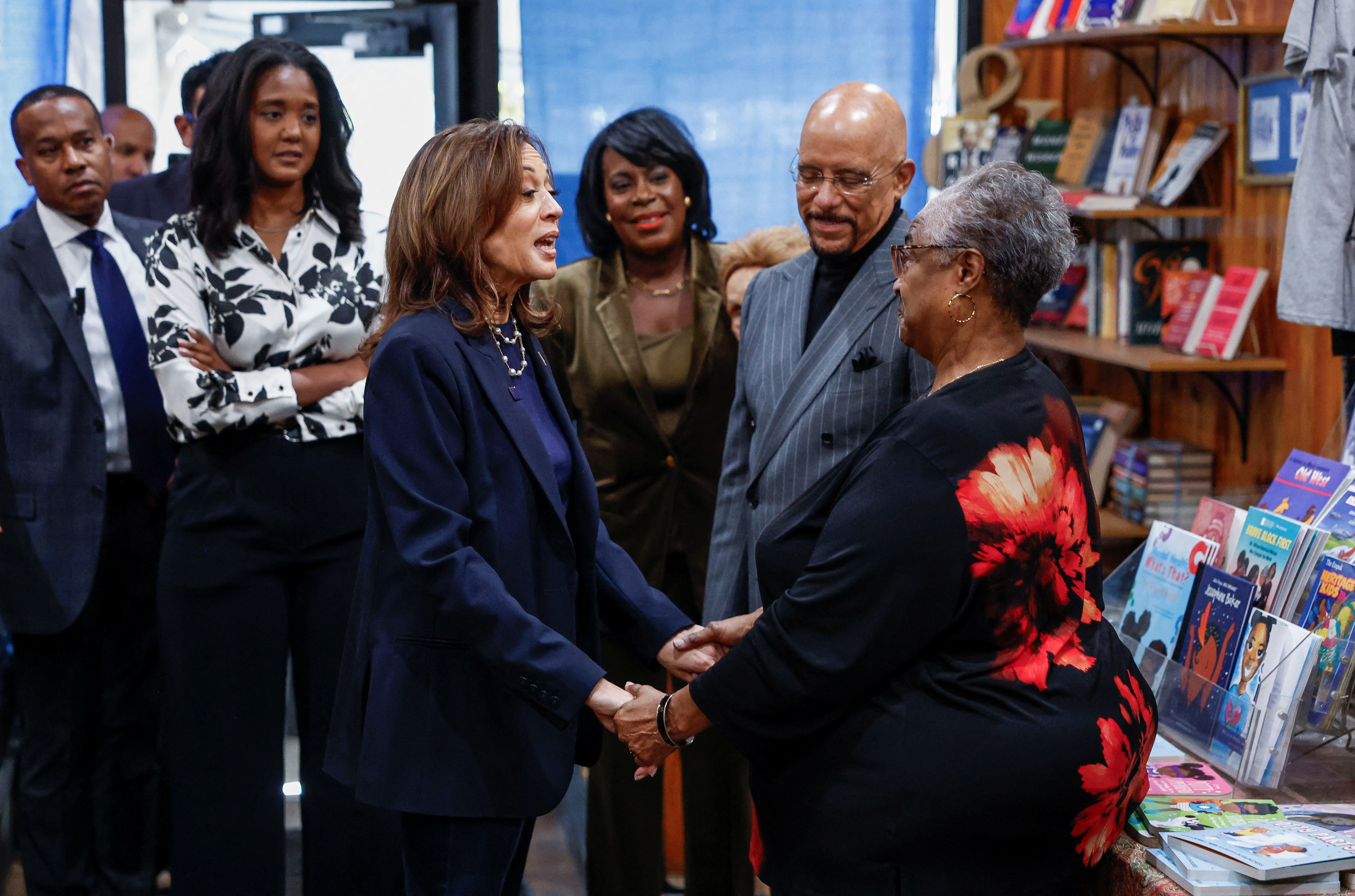 Mayor of Philadelphia Cherelle Parker looks on as Democratic presidential nominee U.S. Vice President Kamala Harris greets a woman during her visit at the Hakim's Bookstore & Gift Shop as she campaigns in Philadelphia, Pennsylvania, U.S. October 27, 2024. REUTERS/Evelyn Hockstein