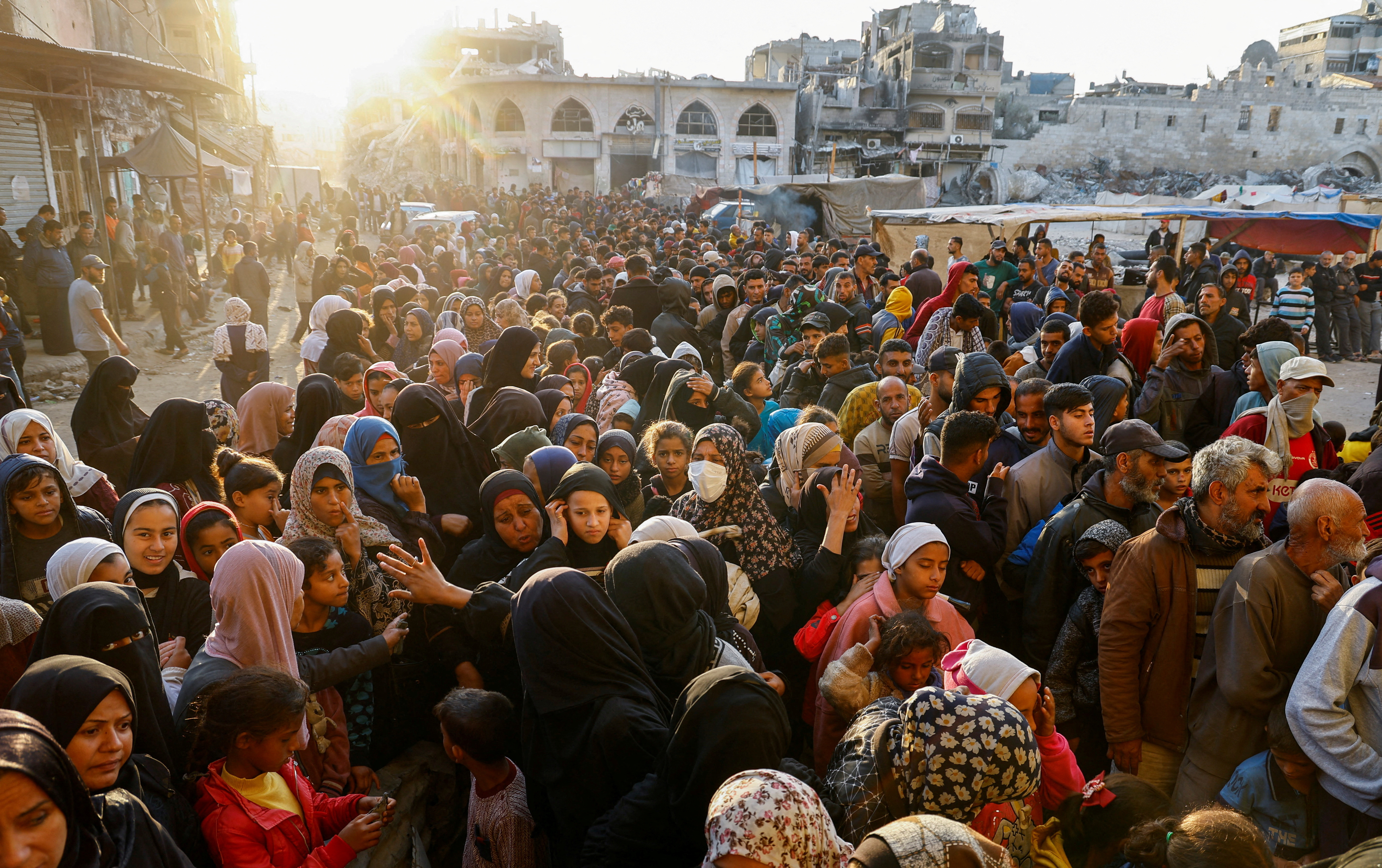 Palestinians gather to buy bread from a bakery,