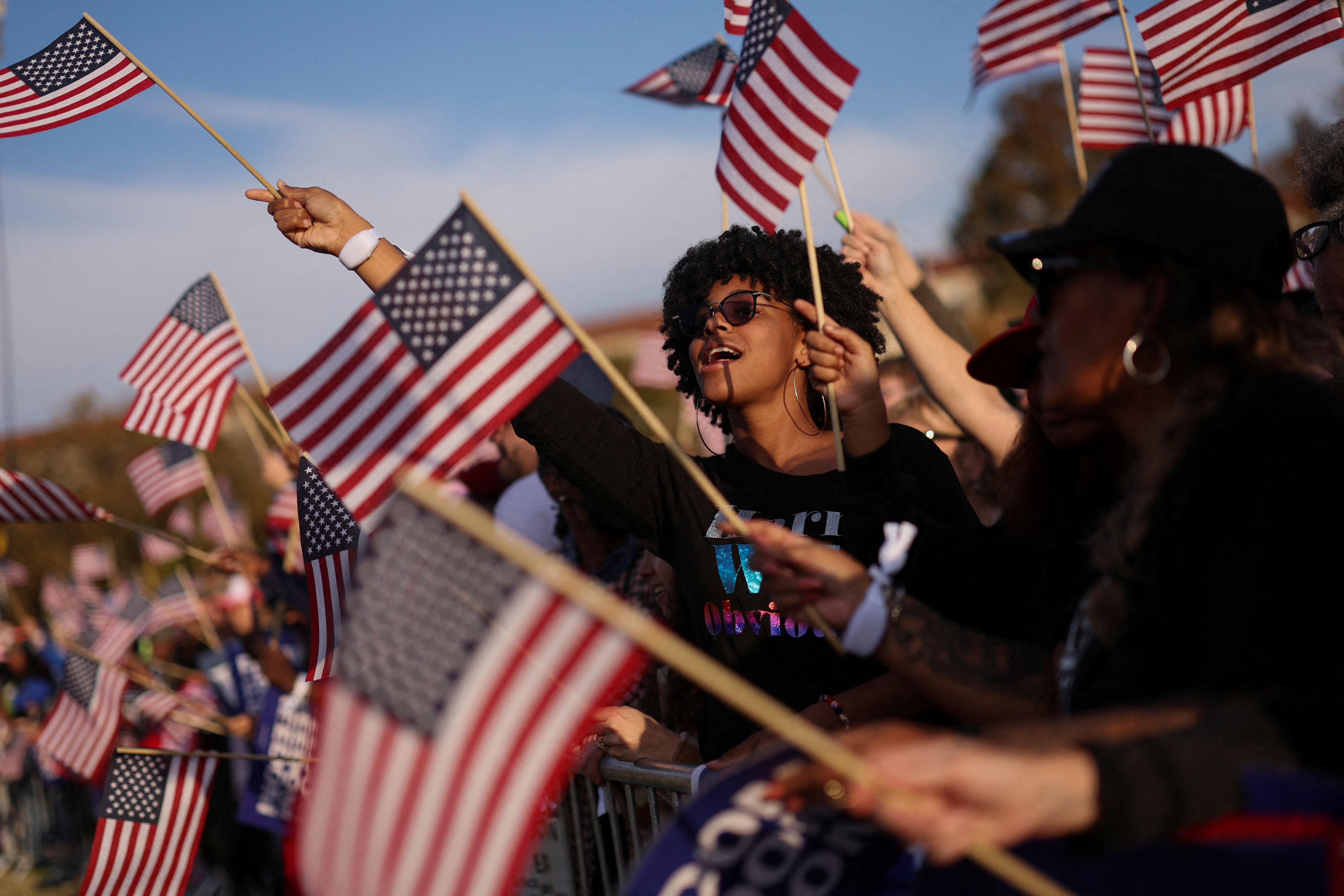 Harris supporters wave flags at a rally in Washington, DC