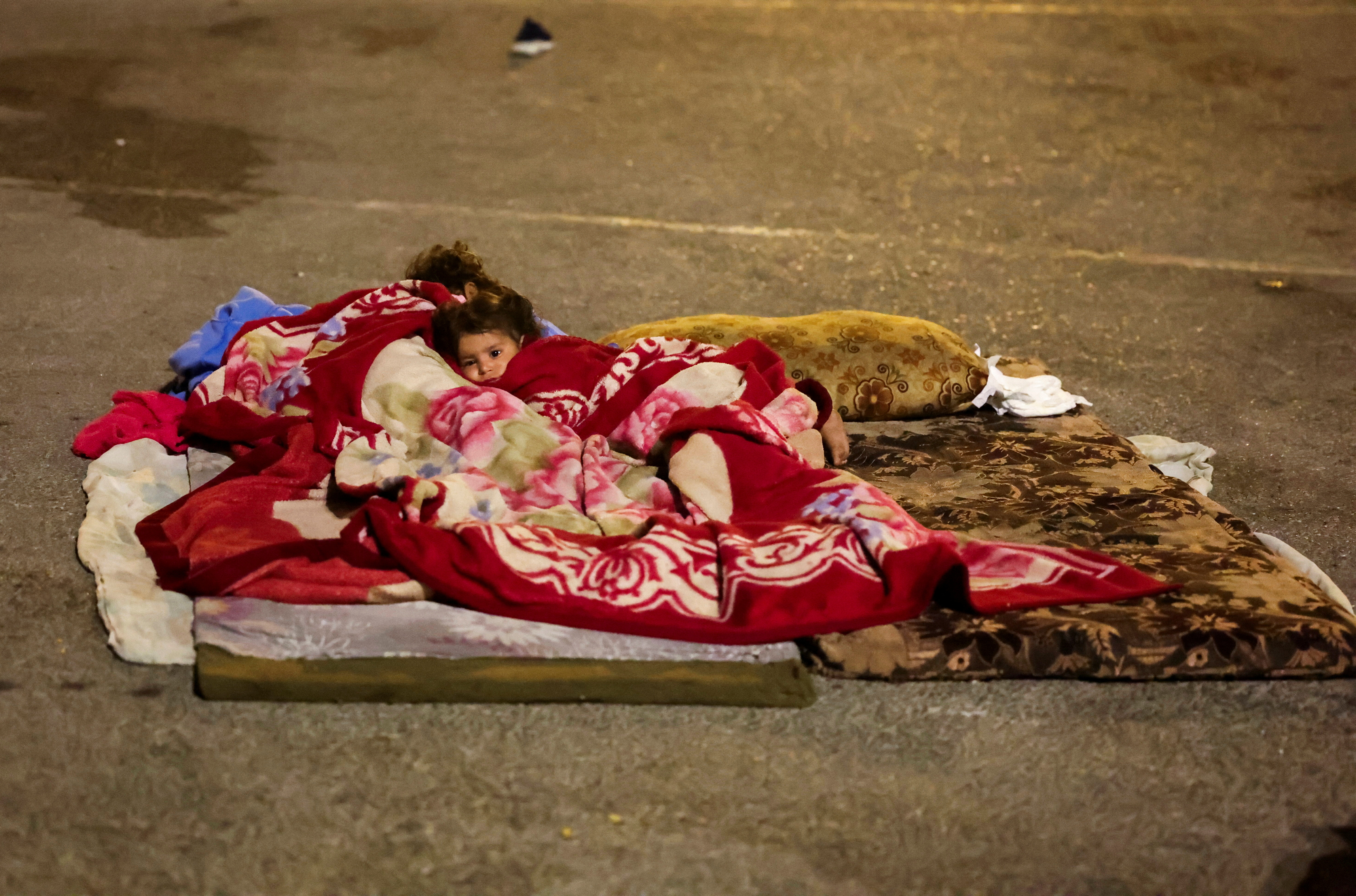 A displaced child rests in the street in Beirut's central Martyrs' Square