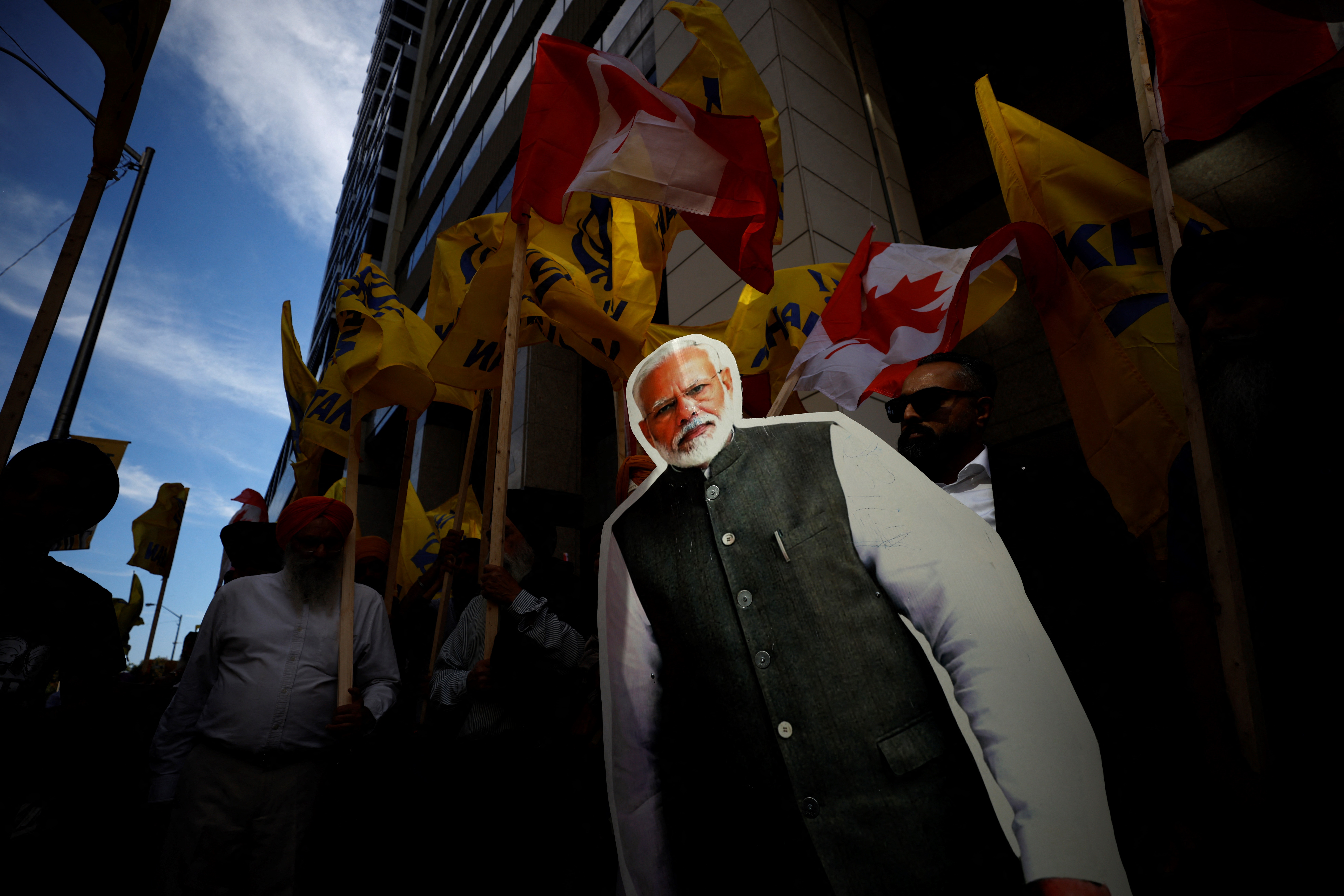 People hold a cutout depicting Indian prime minister Narendra Modi during a Sikh rally outside the Indian consulate a in Toronto to raise awareness for the Indian government's alleged involvement in the killing of Sikh separatist Hardeep Singh Nijjar in British Columbia on September 25, 2023. Prime Minister Justin Trudeau's assertion on September 17, 2023 that agents linked to New Delhi may have been responsible for the June 18 murder of Hardeep Singh Nijjar, a Canadian citizen, sent shockwaves through both countries, prompting the reciprocal expulsion of diplomats. (Photo by Cole BURSTON / AFP)