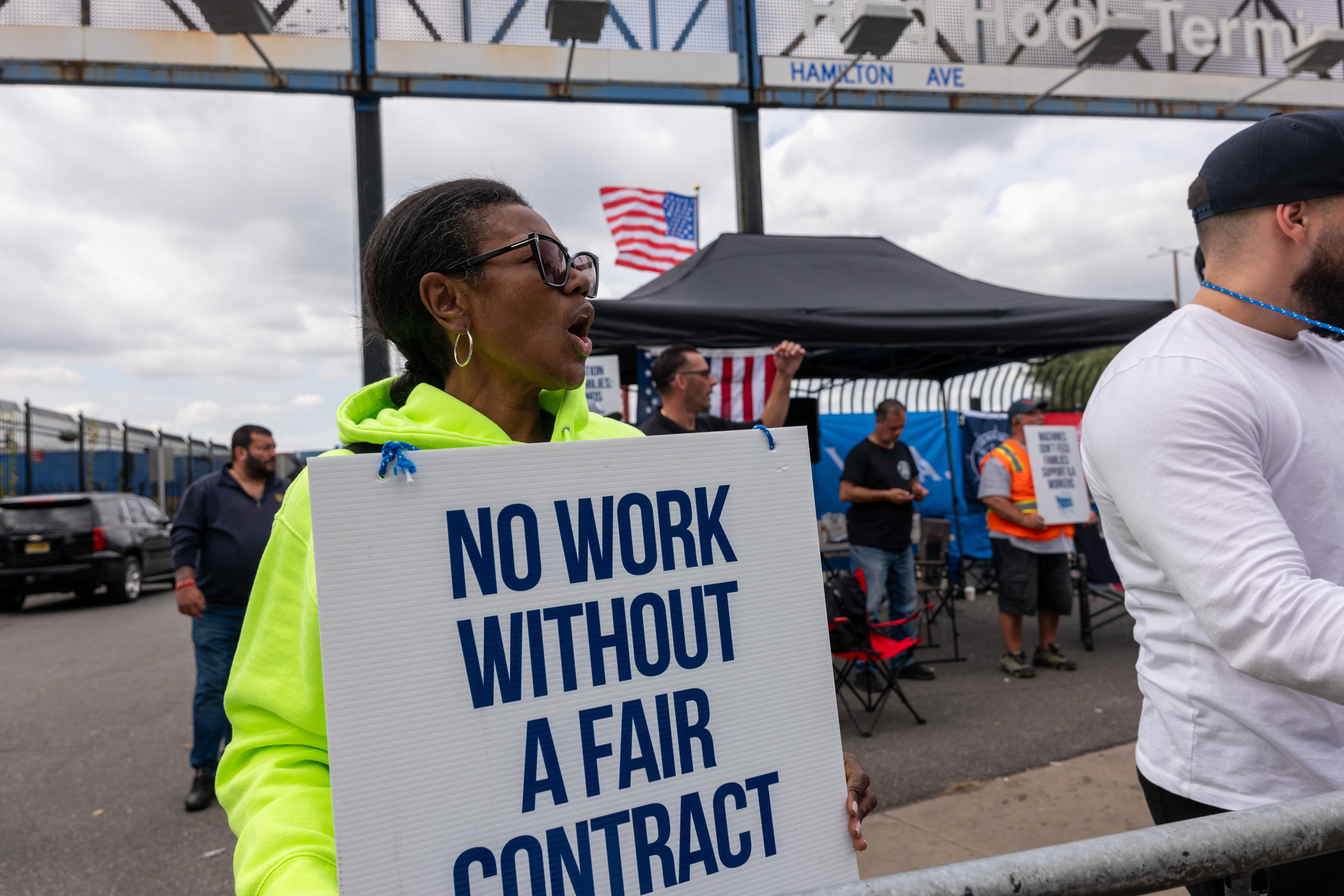 NEW YORK, NEW YORK - OCTOBER 02: Striking workers at the Red Hook Container Terminal in Brooklyn gather after members of the International Longshoremens Association, or ILA, began walking off the job yesterday after 12:01 a.m. ET on October 02, 2024 in Brooklyn, New York. The strike of over 50,000 workers at ports along the East Coast and Texas comes after the just-expired master contract with the United States Maritime Alliance, or USMX. Workers are striking over wages, automation, and other issues. Spencer Platt/Getty Images/AFP (Photo by SPENCER PLATT / GETTY IMAGES NORTH AMERICA / Getty Images via AFP)