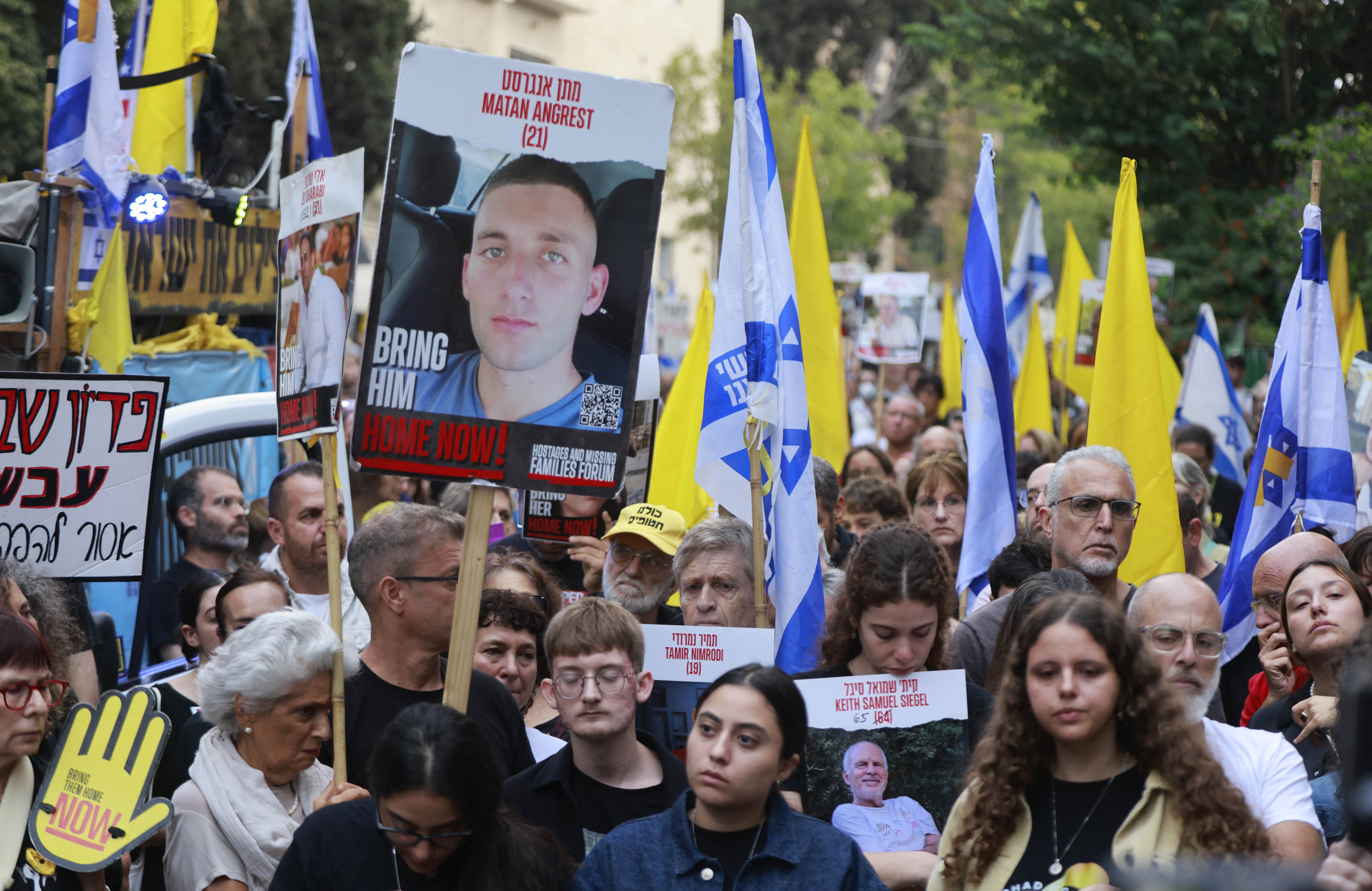 A photo of captive soldier Matan Angrest is seen as relatives and supporters of Israeli hostages taken by Palestinian militants on the October 7 Hamas attack and held in Gaza, hold images of their loved ones during a protest calling for their release in front of Prime Minister Benjamin Netanyahu residency in Jerusalem on October 7, 2024
